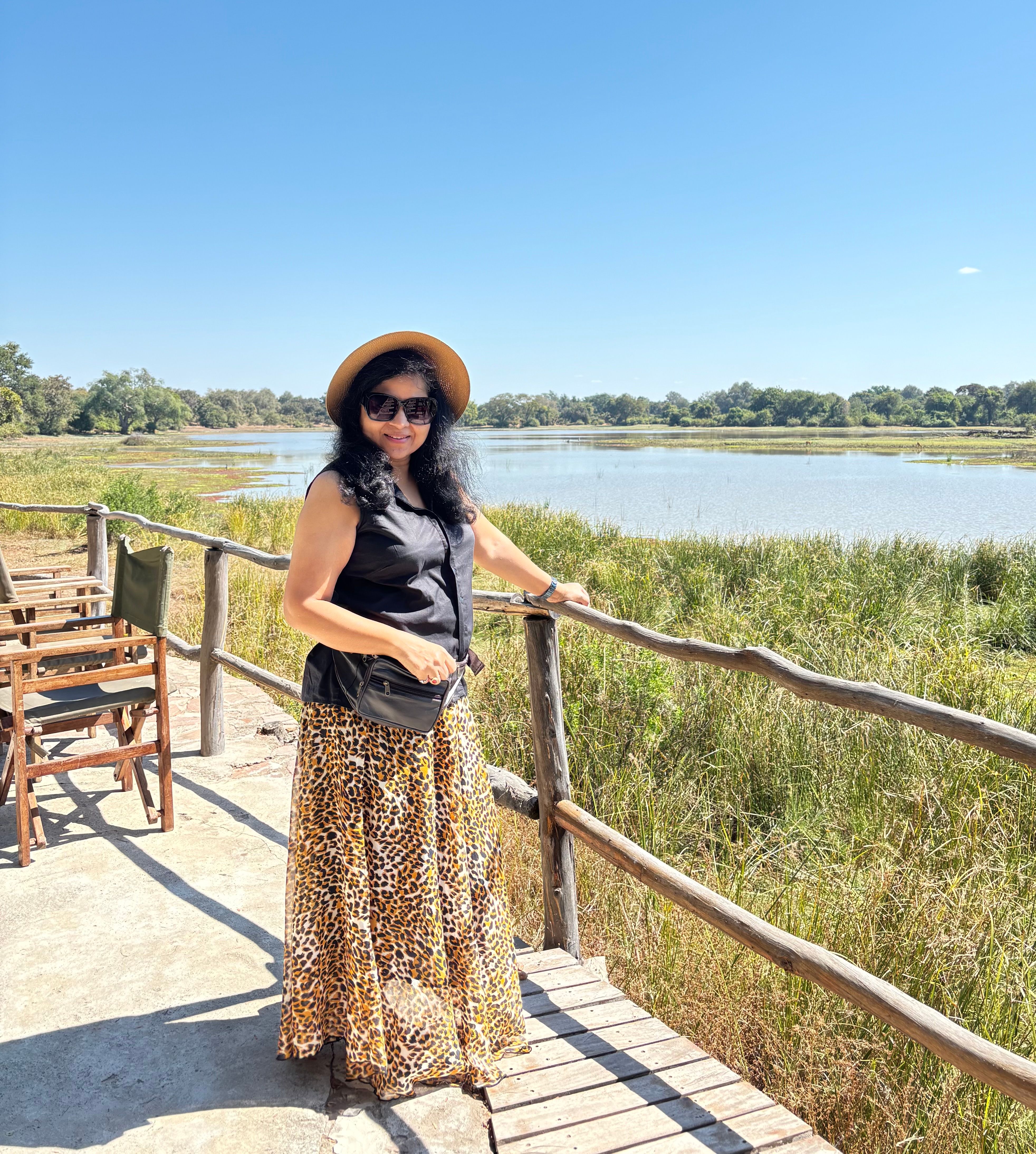 Hemakshi by a wooden bridge over a lagoon