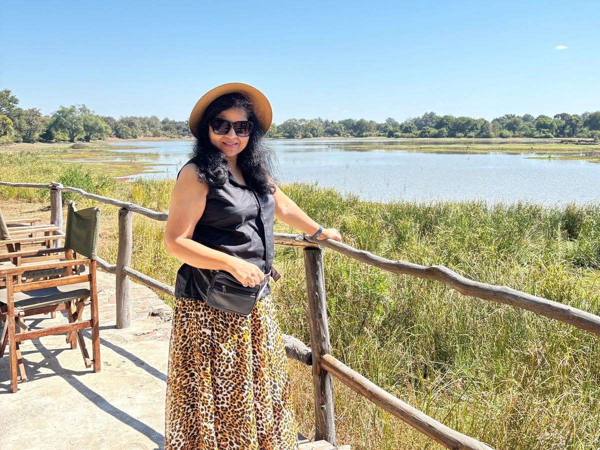 Hemakshi by a wooden bridge over a lagoon