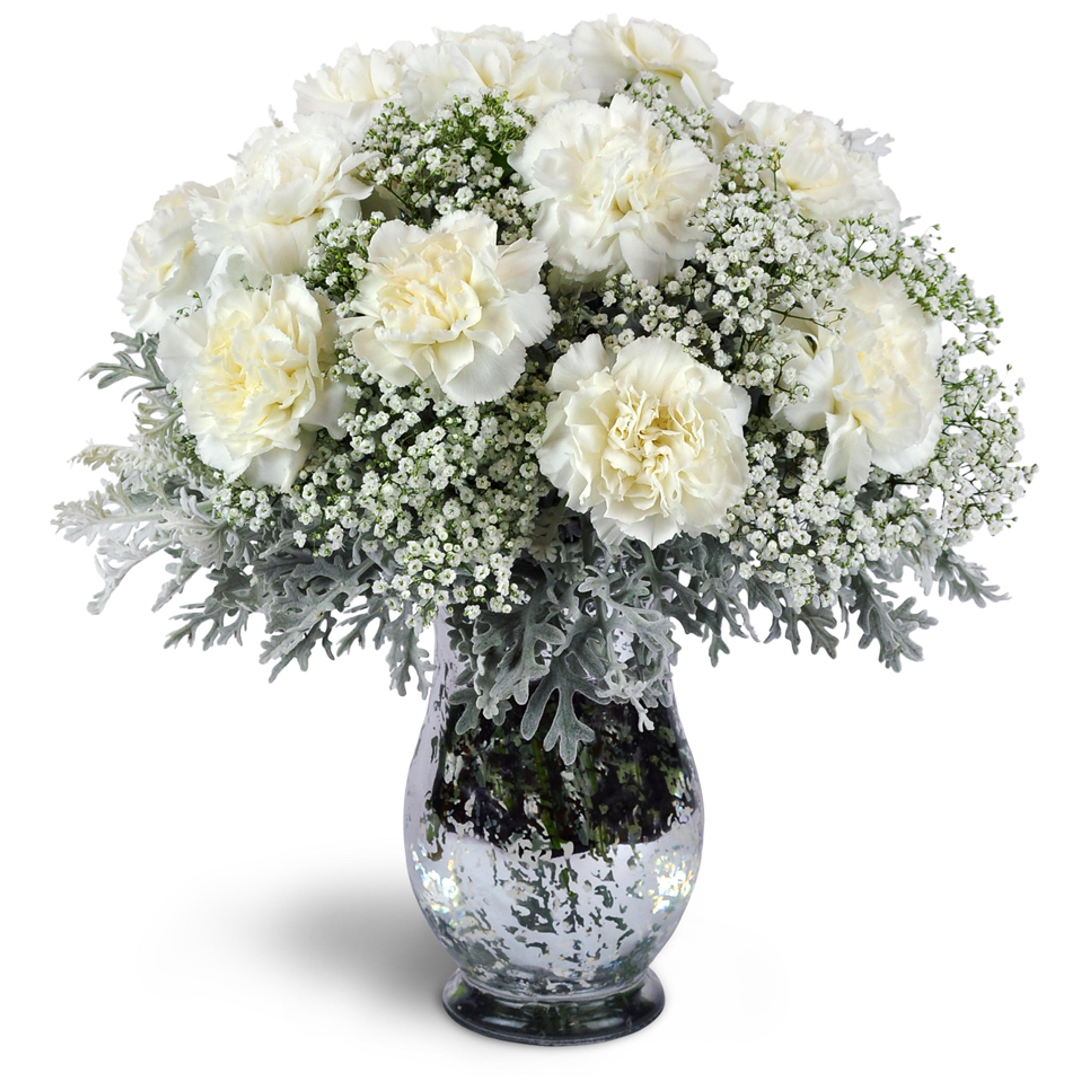 A white flower arrangement with white carnations arranged with airy baby’s breath and dusty miller.