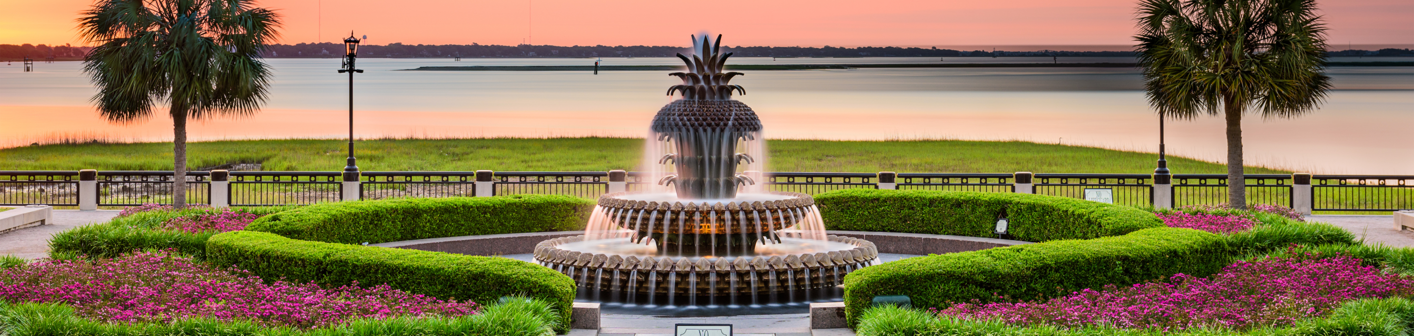 a fountain in the shape of a pineapple in a garden