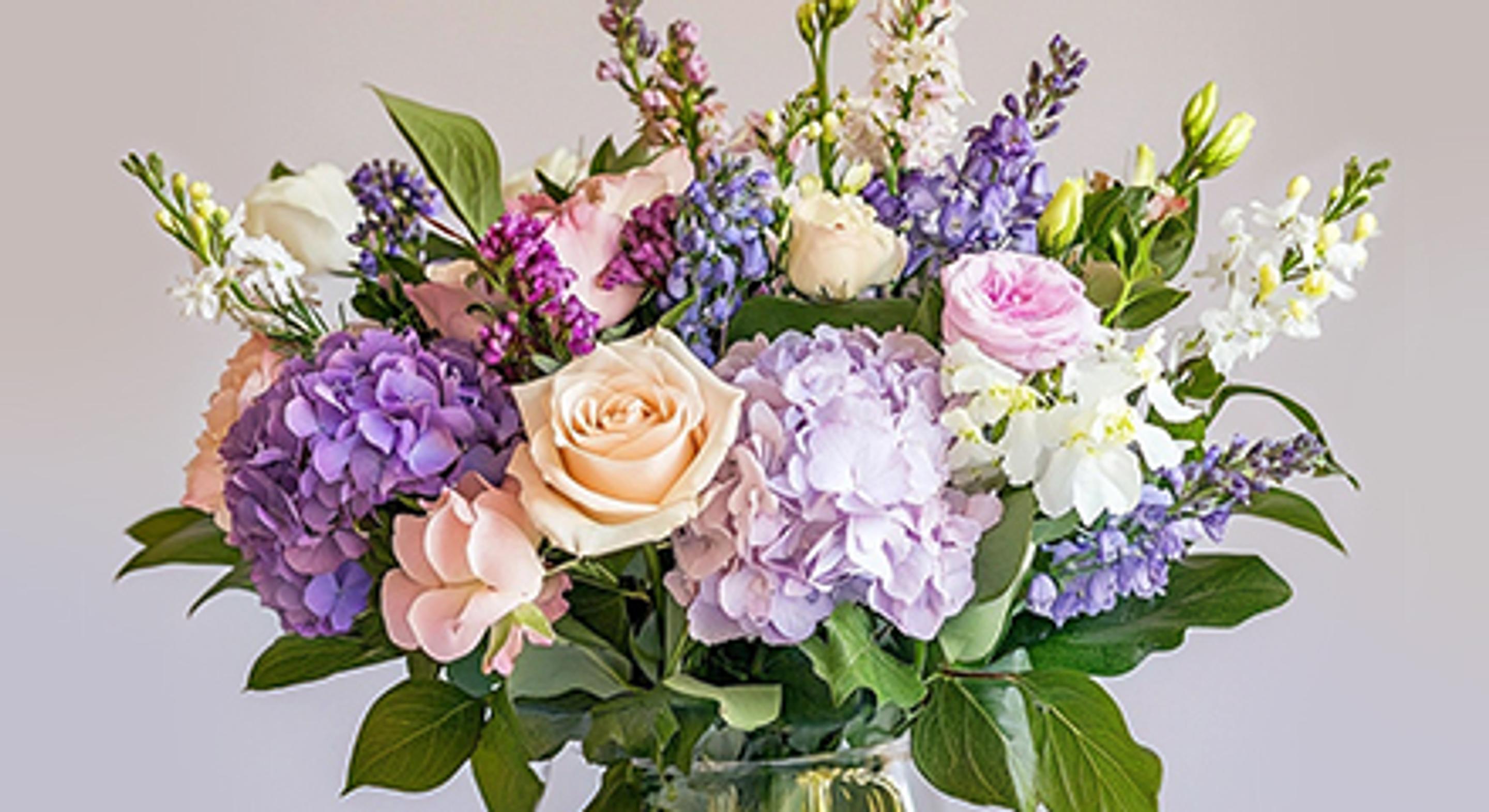 Elegant floral arrangement featuring roses and hydrangeas, perfect for birthdays or special occasions.