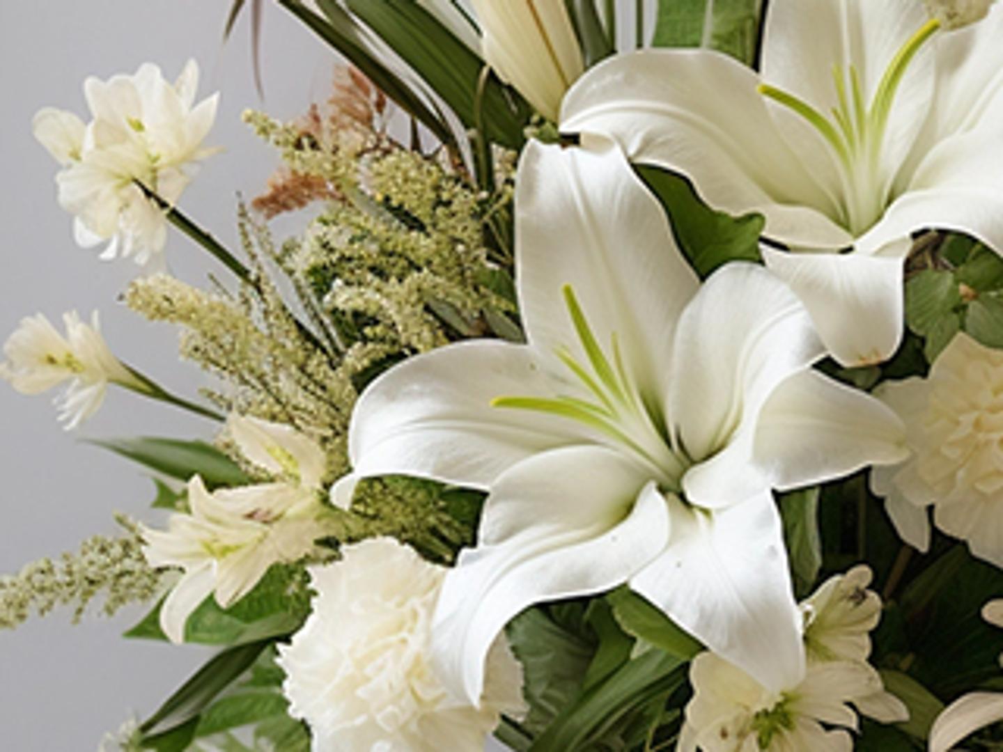a close up of a bouquet of white flowers on a table