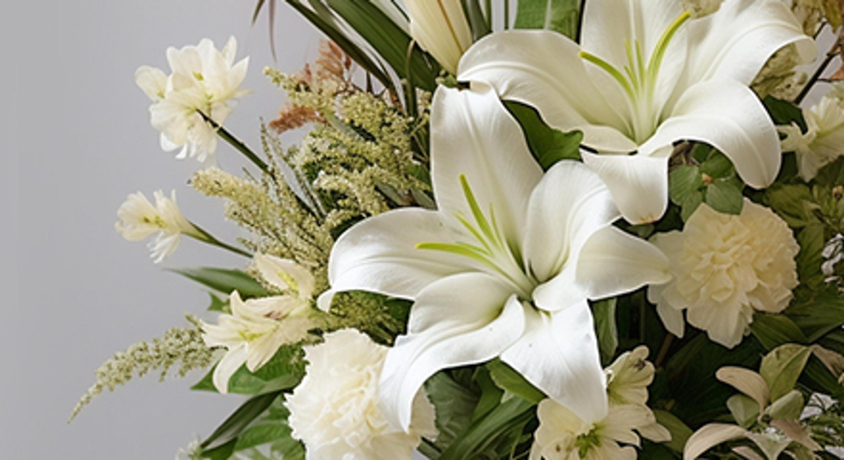 White sympathy and funeral floral arrangement