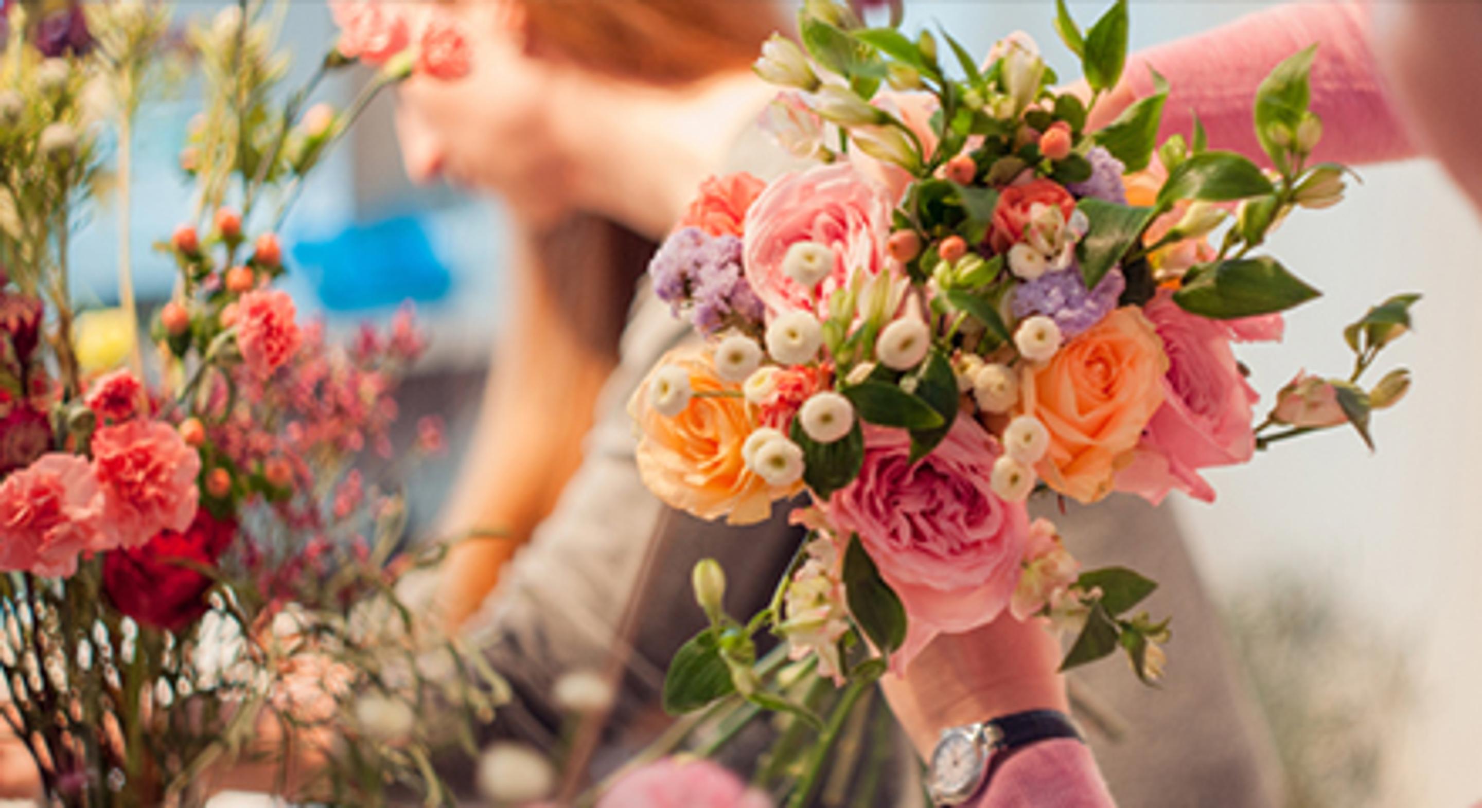Florist arranging a bright colored floral bouquet