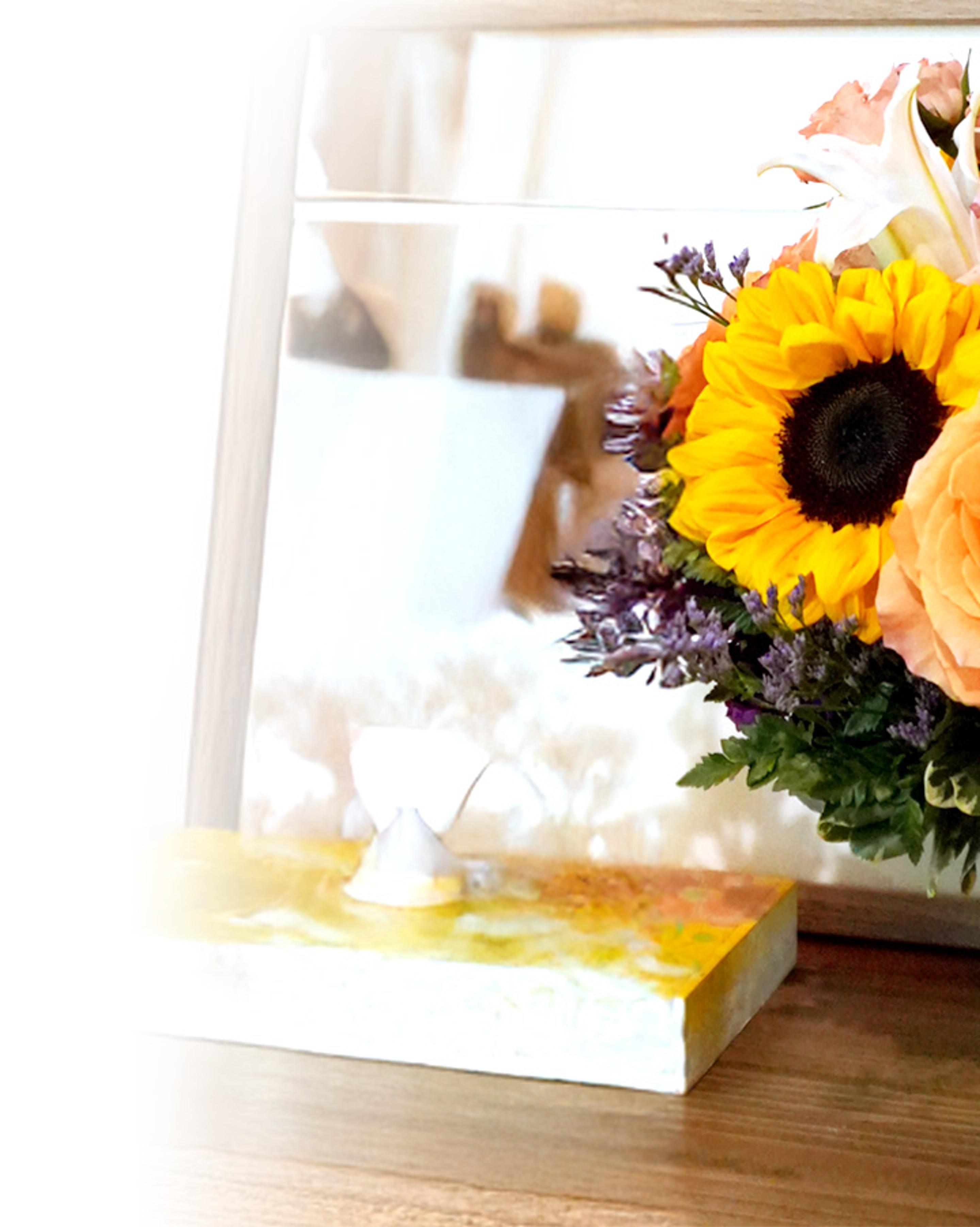 a bouquet of flowers is sitting on a table next to a box of tissues
