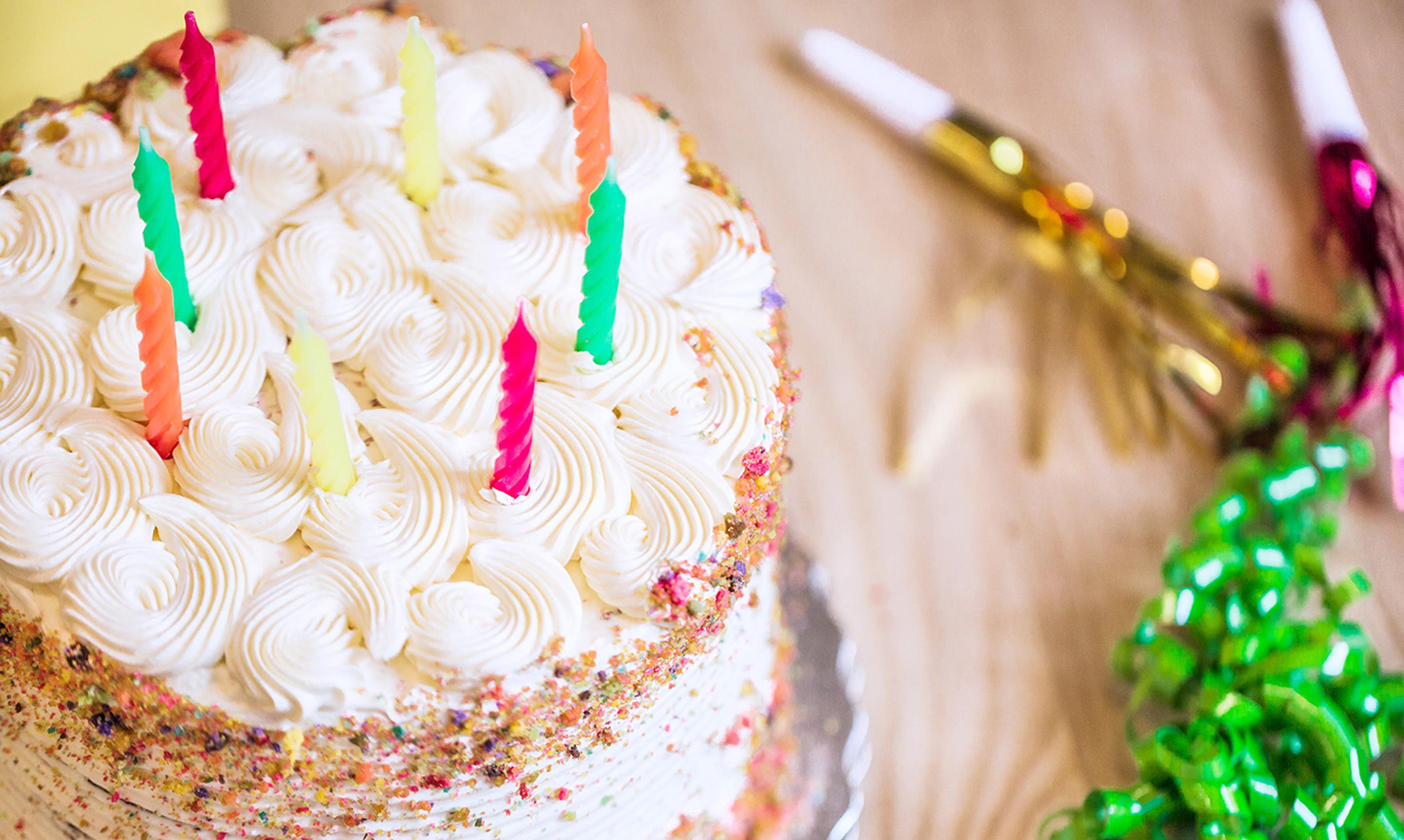 a birthday cake with candles on it is on a table