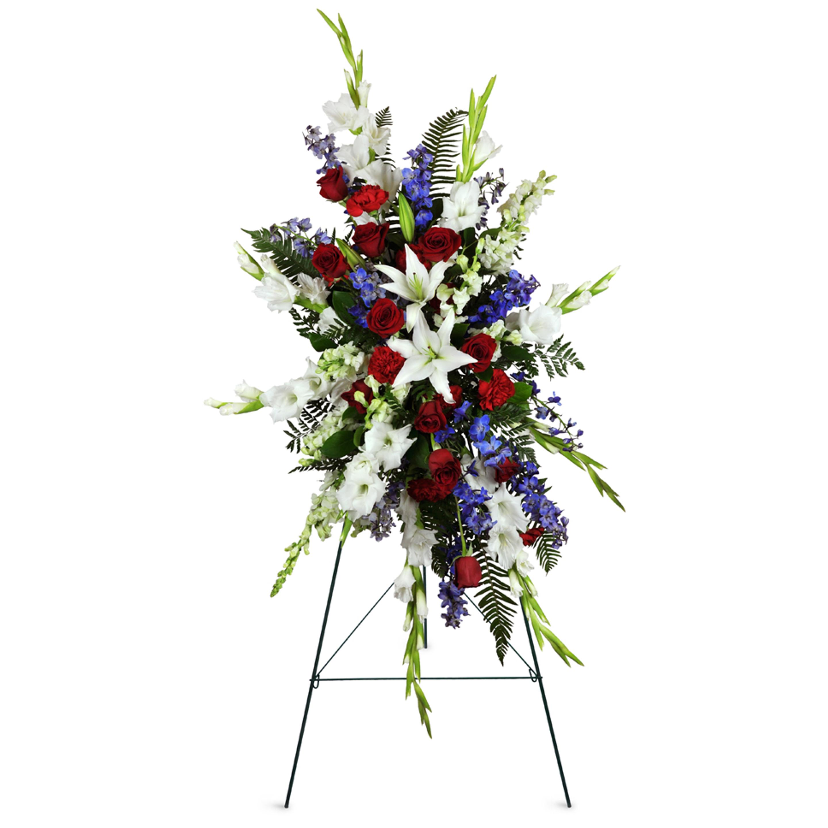 A standing spray with white, red, blue, and green flowers. Tall and elegant as a tribute for funerals.