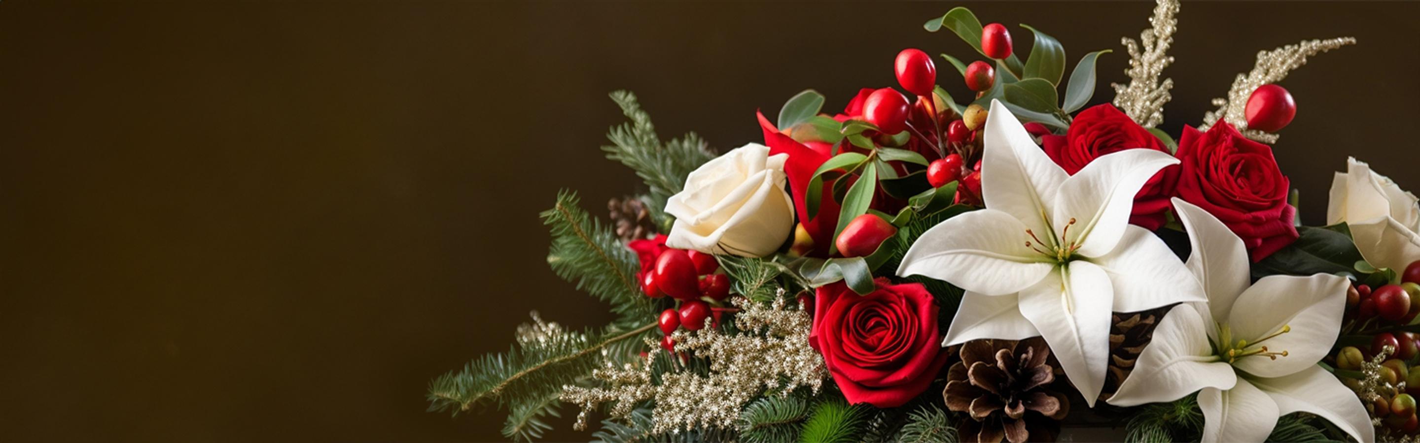 Christmas-themed holiday flower arrangement against a dark background. Flowers featuring red roses, white roses, holly, pine cones and beautiful greenery.
