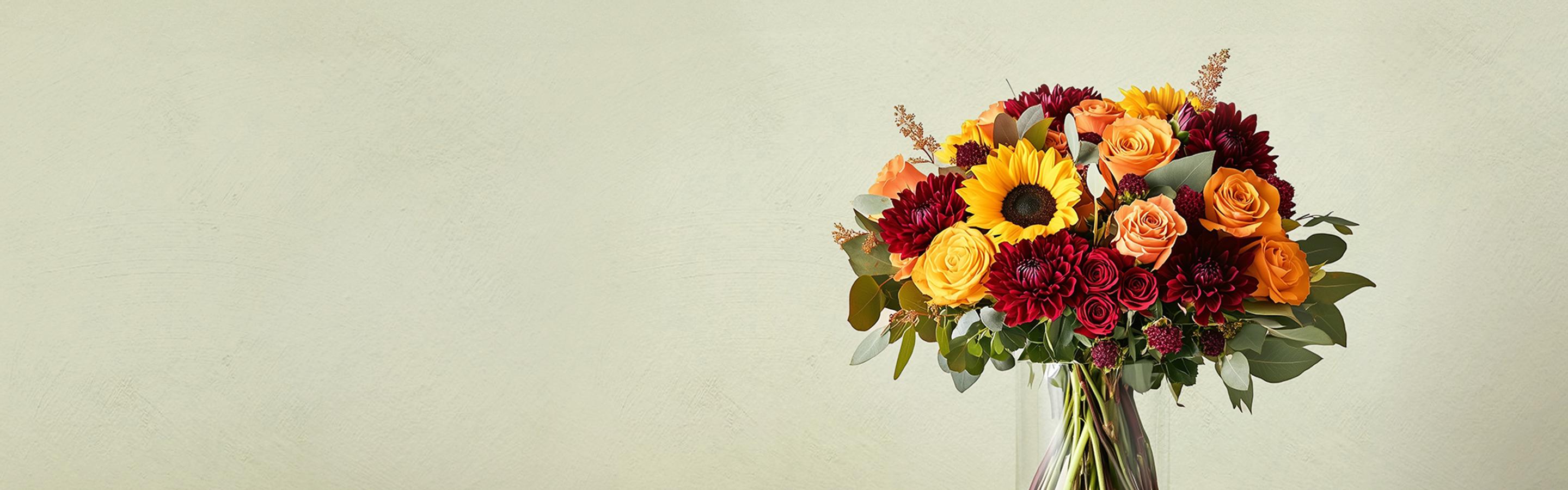 Fall flower arrangement with sunflowers, roses and chrysanthemums.