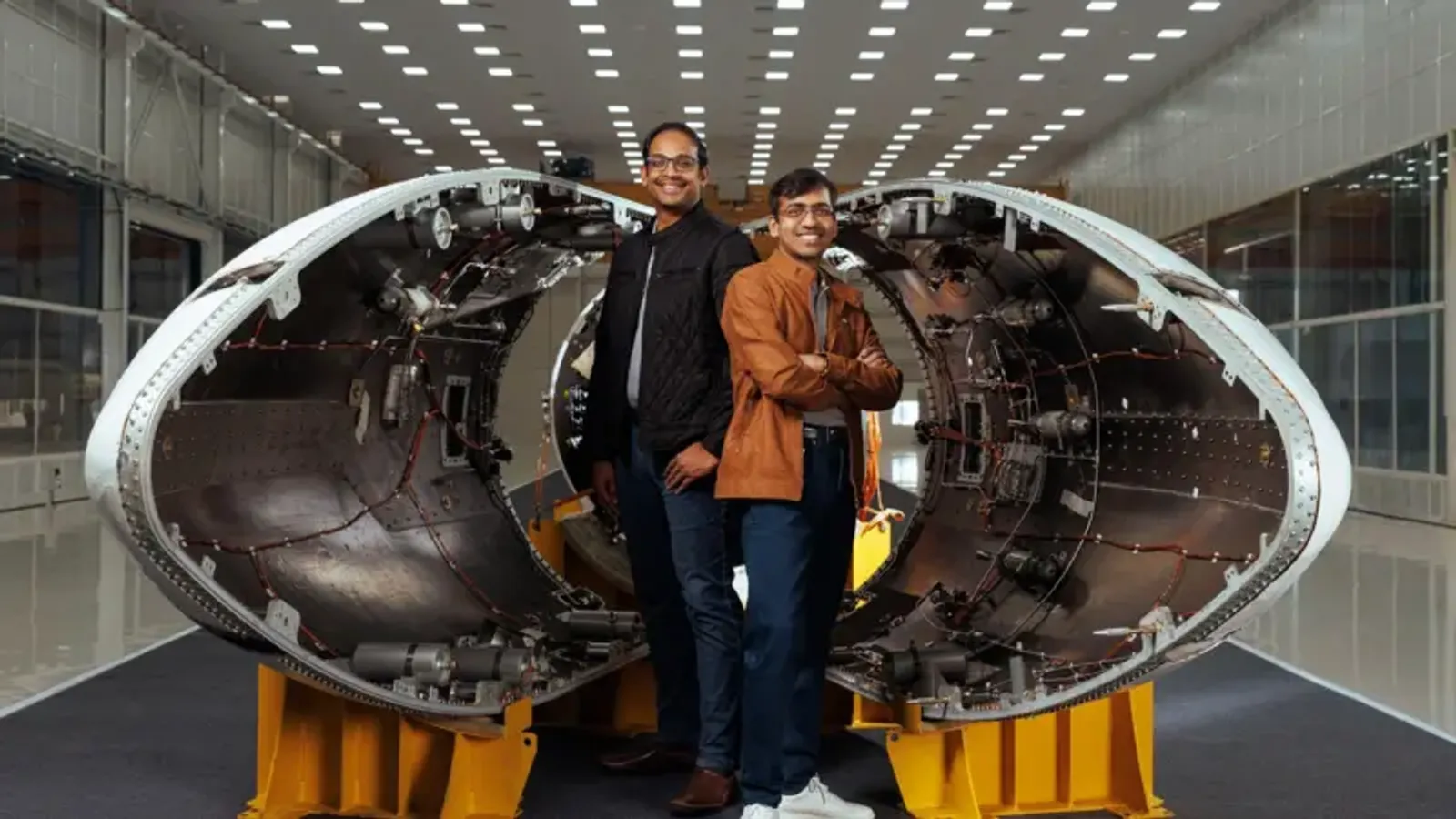 Pawan Chandna and Naga Bharath Daka standing in front of Vikram-1 split nose cone