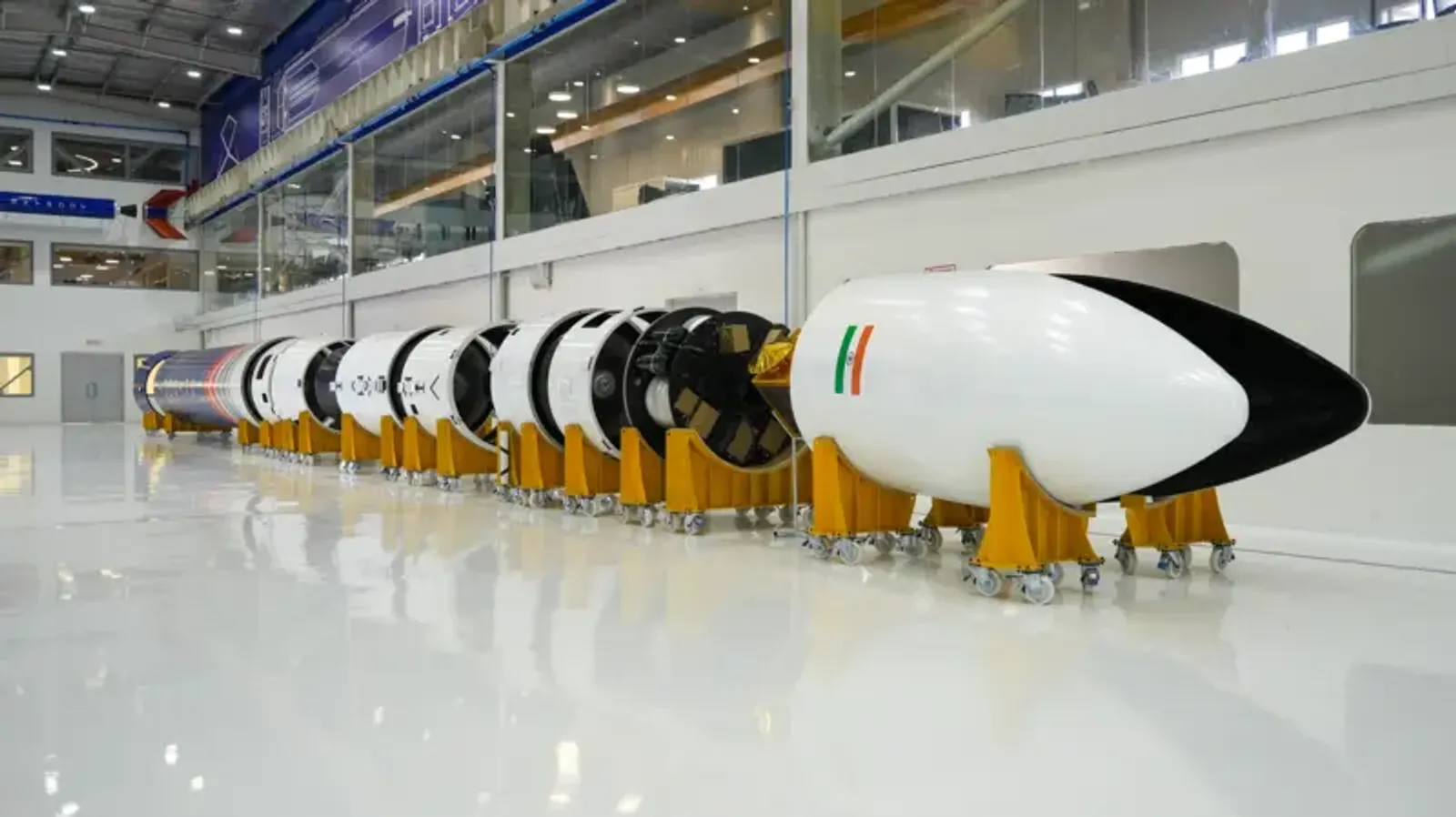 Modular stages of Vikram-1 rocket placed on yellow support frames in cleanroom