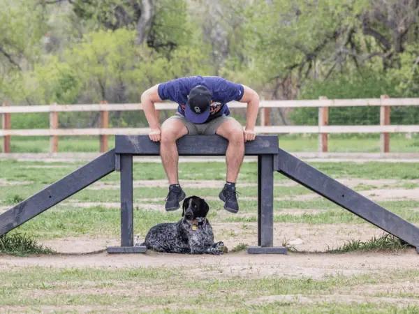A dog parent and a dog at the David M. Sonka Dog Park’s agility course near Highlands Ranch