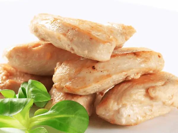 Close up of cooked, unseasoned chicken, the healthiest human food that cats can eat