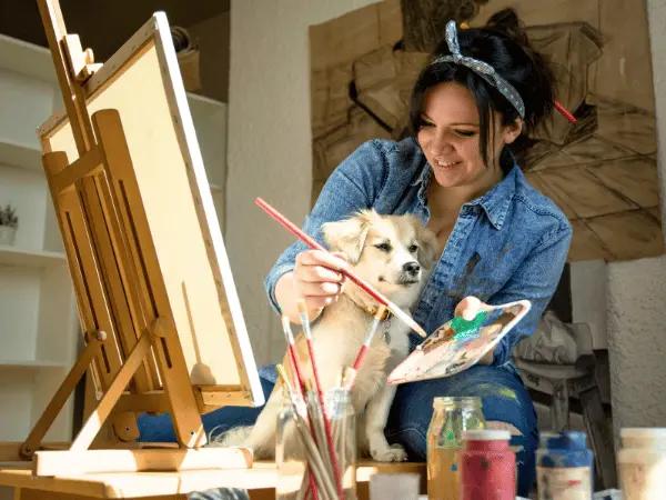 A pet parent painting their dog, representing a paint-your-pup dog-friendly event in Colorado Springs