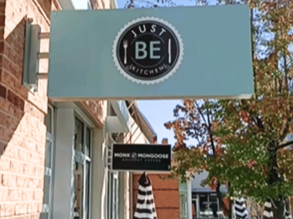 The signage of Just BE Kitchen, a dog friendly patio or dog friendly restaurant in Denver