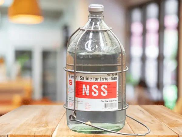 A bottle of normal saline solution used for cat wound treatment or cat wound care