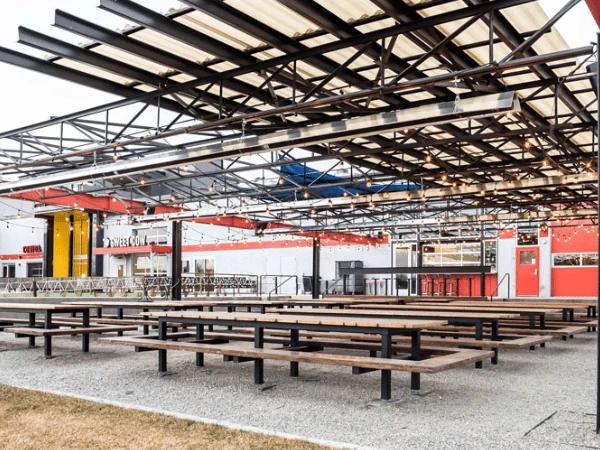 The dog friendly patio of Stanley Beer Hall, a dog friendly bar near Central Park Denver
