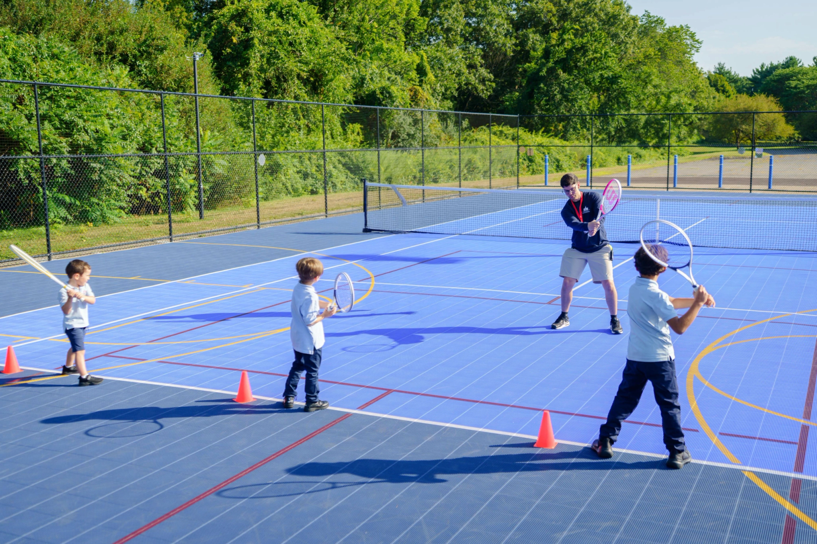 SELA's outdoor multi-sport court in Hingham, lined and netted for tennis