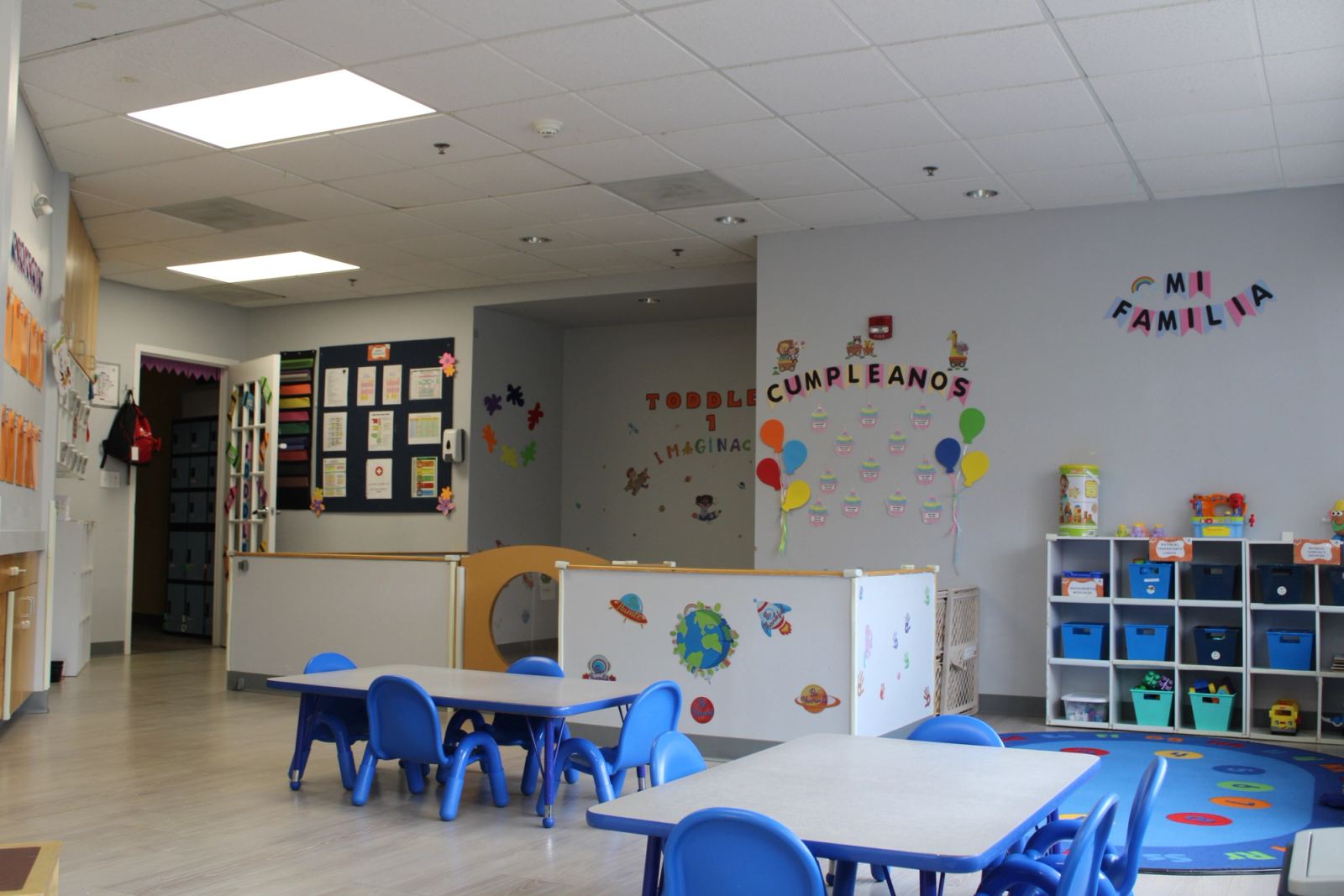 A bright Early Global Education classroom at SELA's Hingham campus, with child-height tables, cubbies, and a reading corner.
