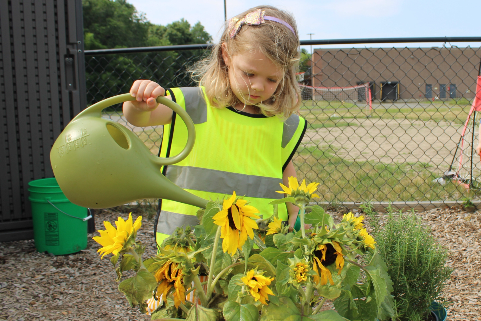 SELA students play together in the outdoor yard on a sunny day.