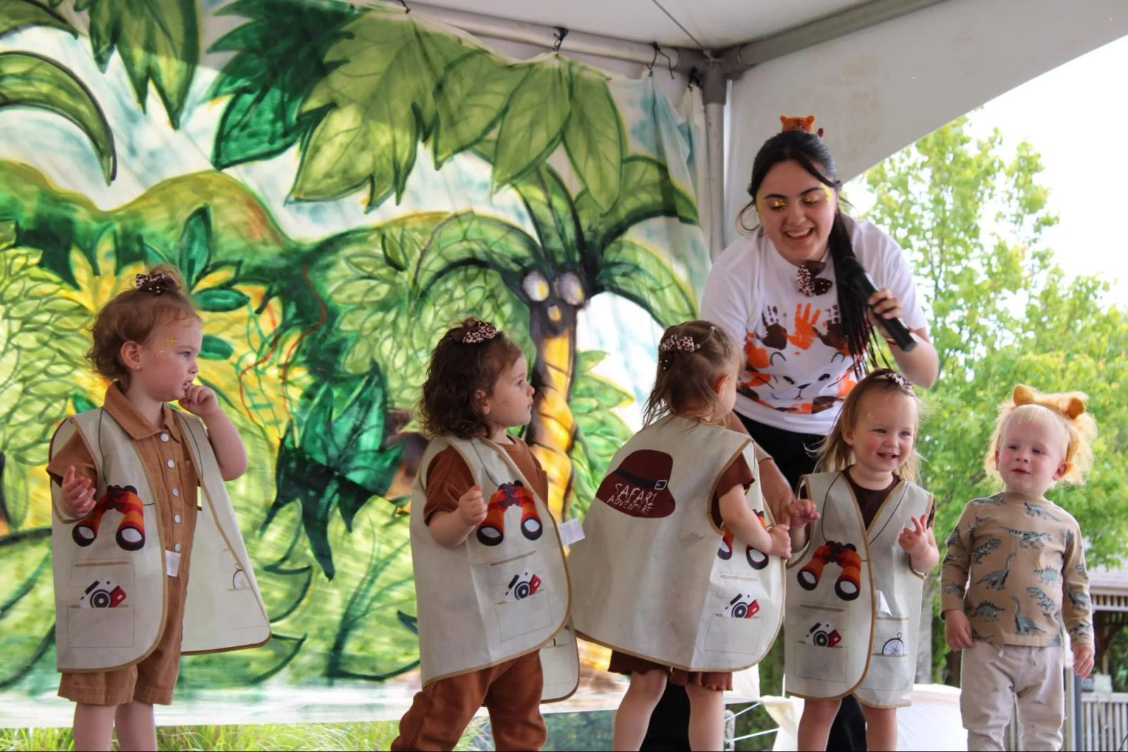 Children and families gather outdoors at a SELA campus event.