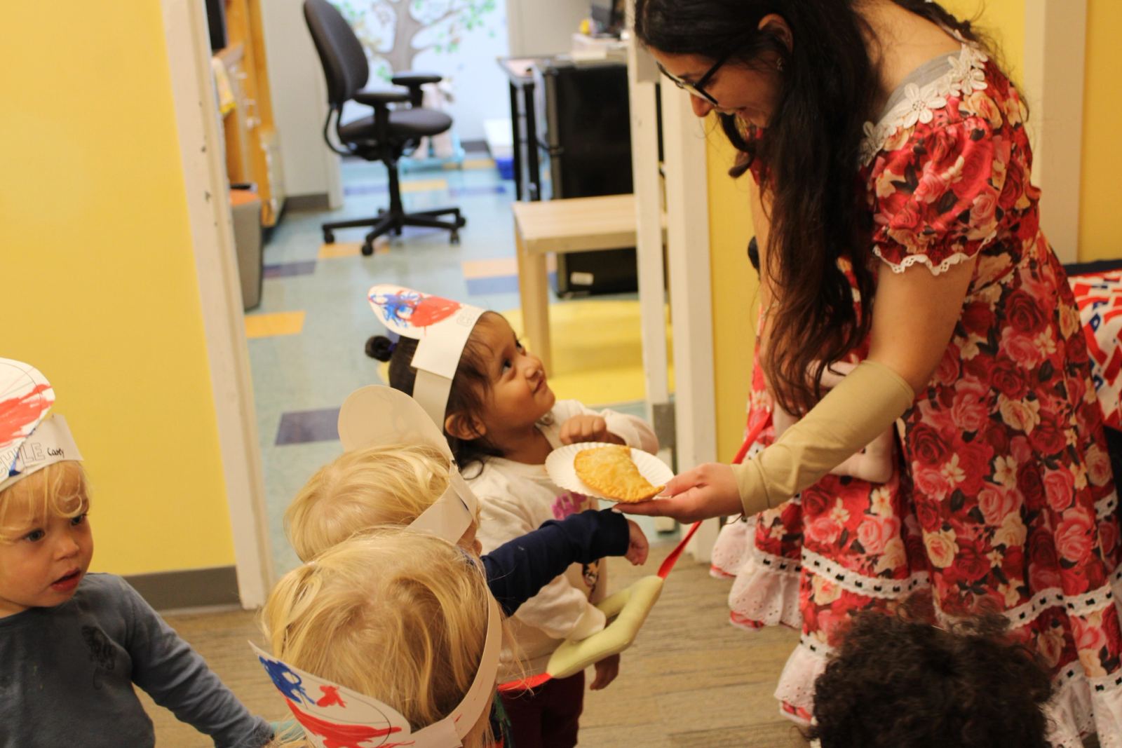 A SELA faculty member leads a small-group lesson with attentive students.