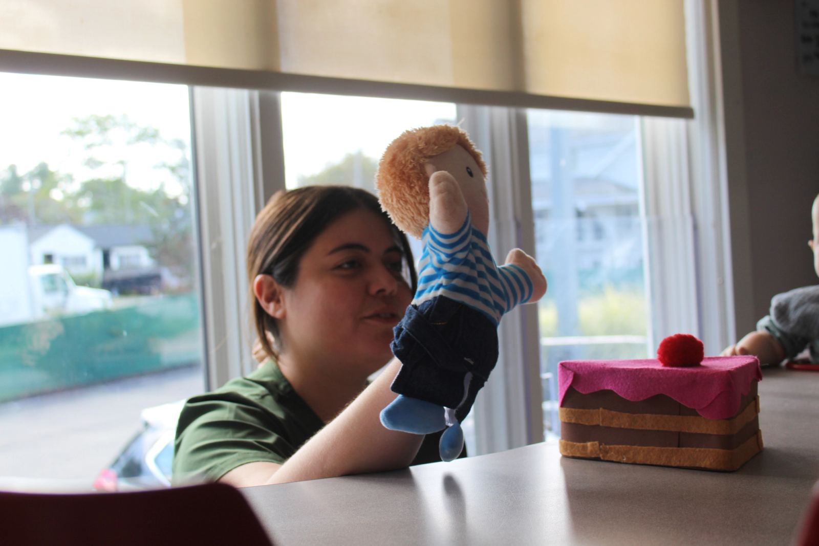 A SELA Spanish Immersion Teacher conducting a lesson for Infants using a puppet.