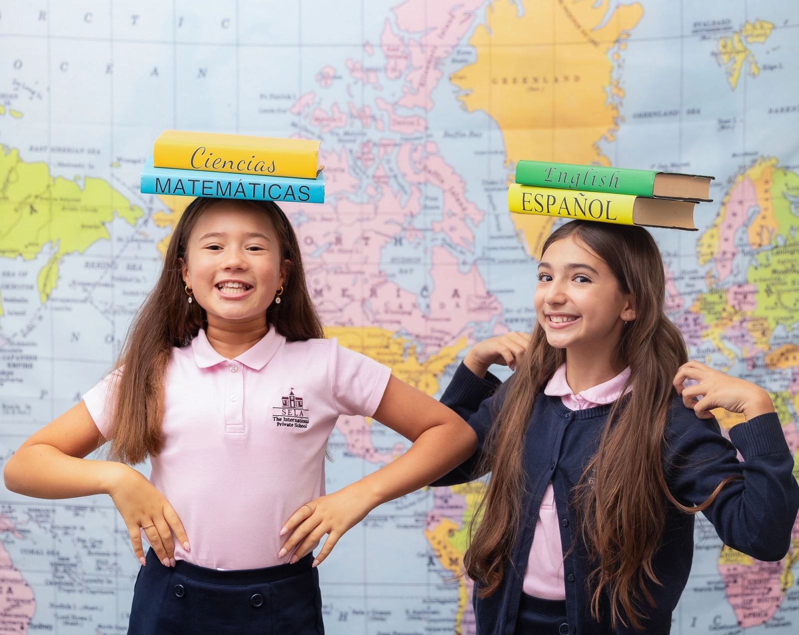 A bright Spanish-immersion Toddler classroom at SELA — Mi Familia wall décor, a world map, and warm, colorful learning spaces