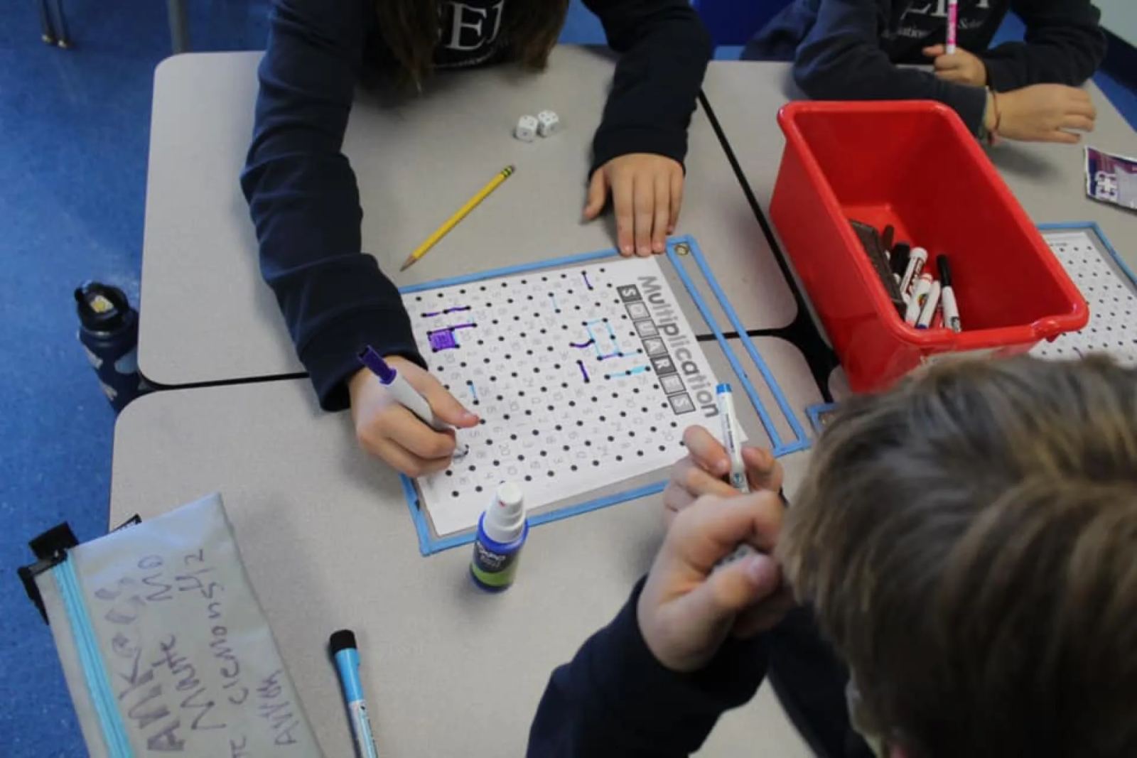 SELA elementary students collaborate on a lesson in the classroom.
