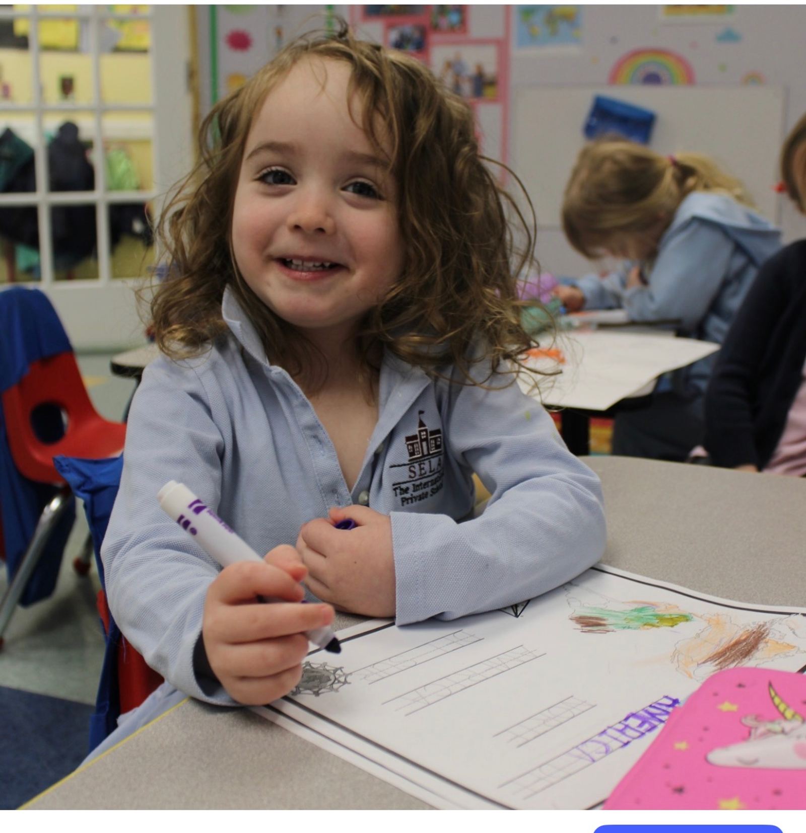 SELA elementary students collaborate on a lesson in the classroom.