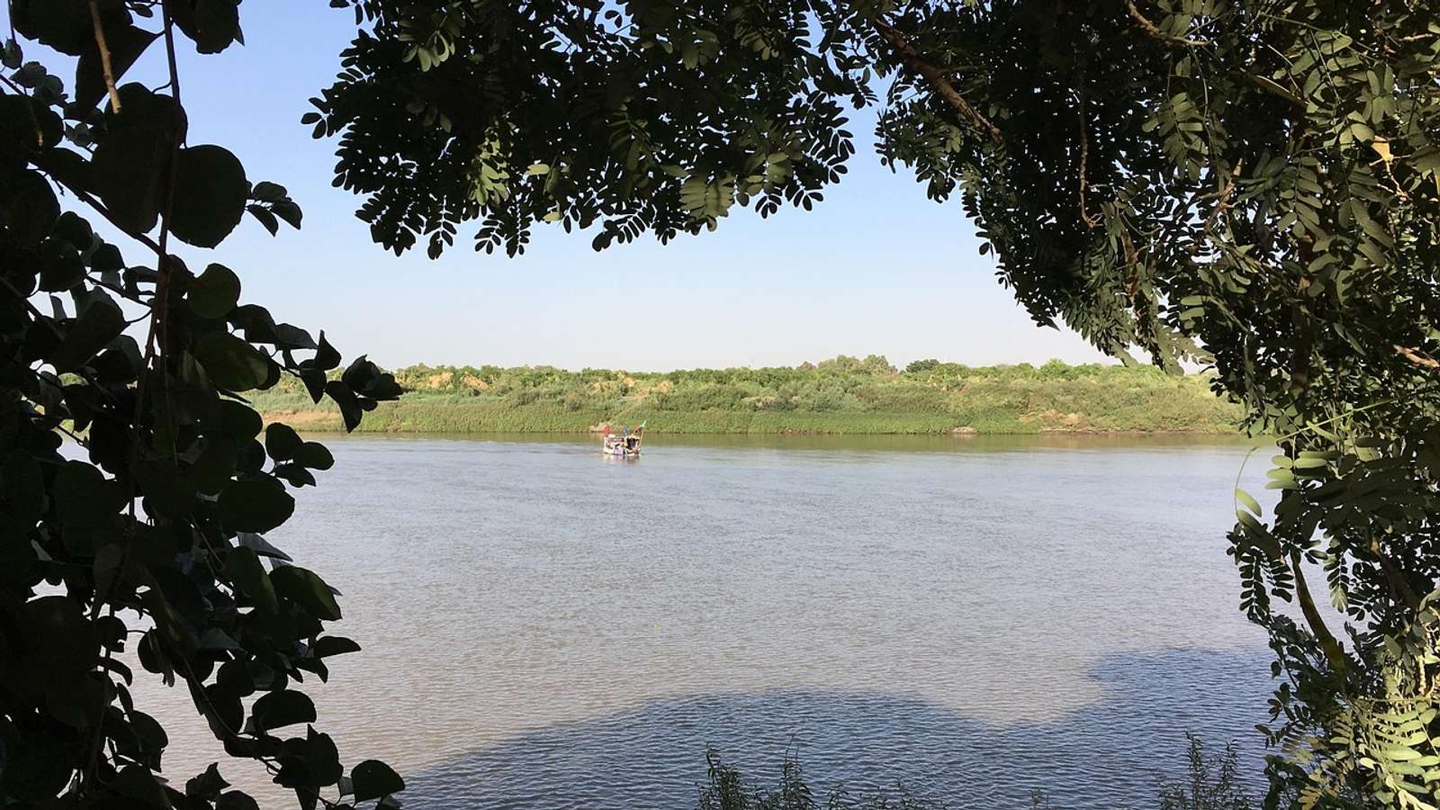 The Nile near Khartoum seen through overhanging tree branches