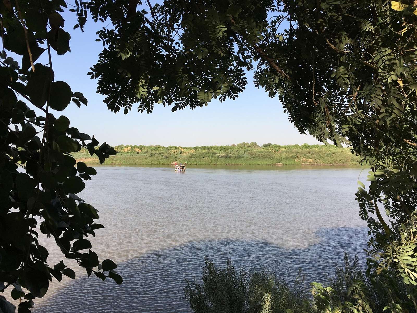 The Nile near Khartoum seen through overhanging tree branches