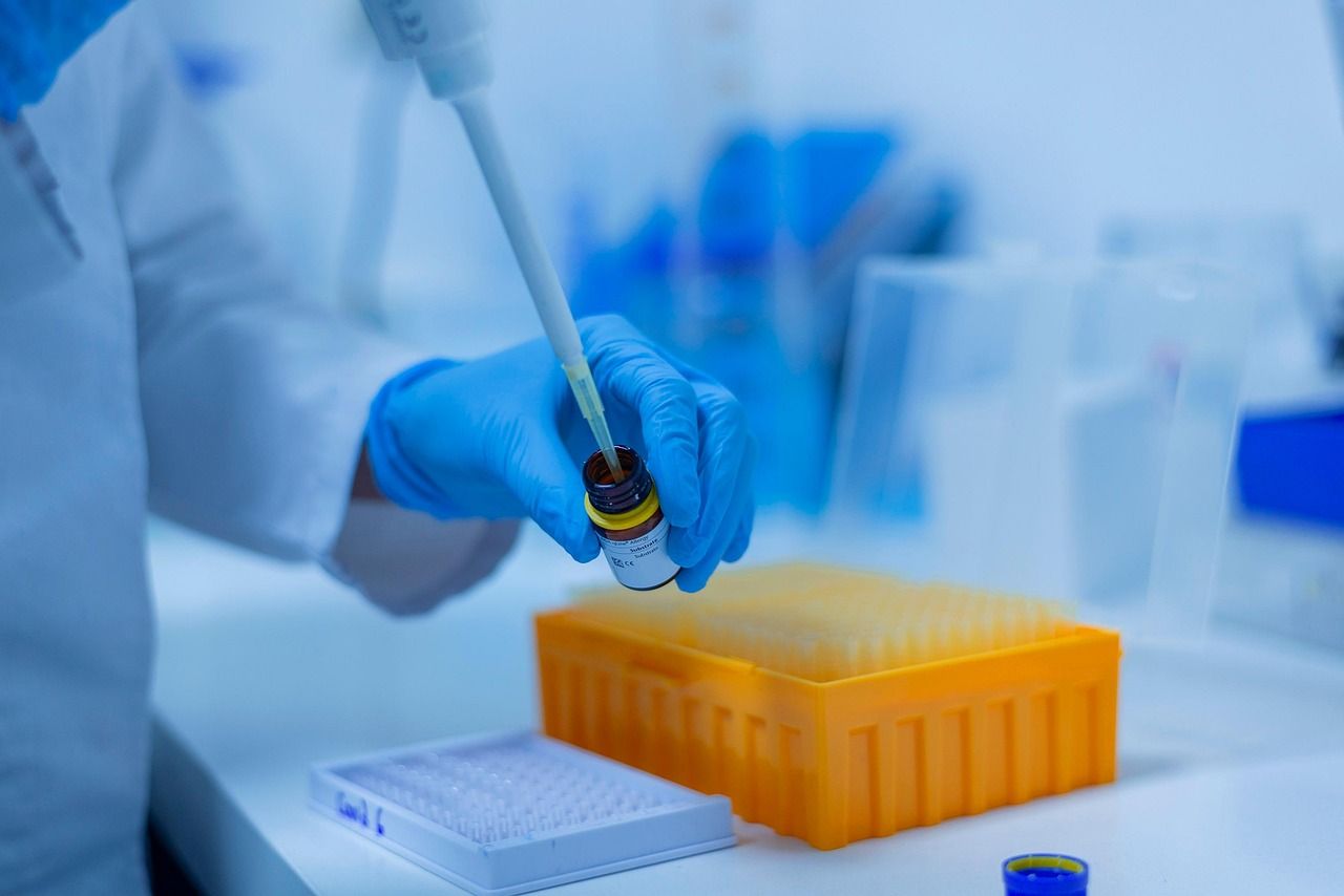 A scientist using a pipette in a laboratory