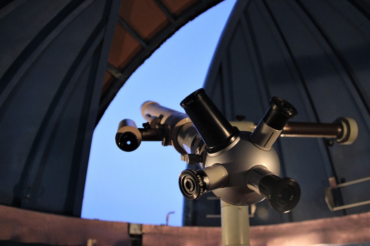 An astronomical observatory dome under a starry night sky