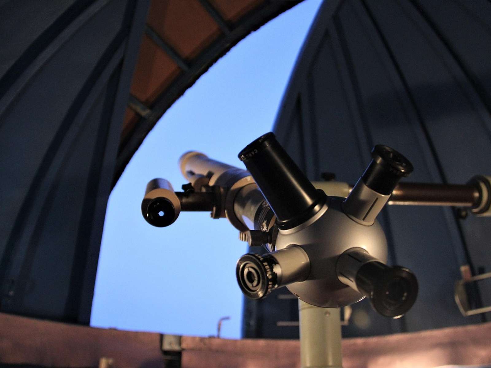 An astronomical observatory dome under a starry night sky