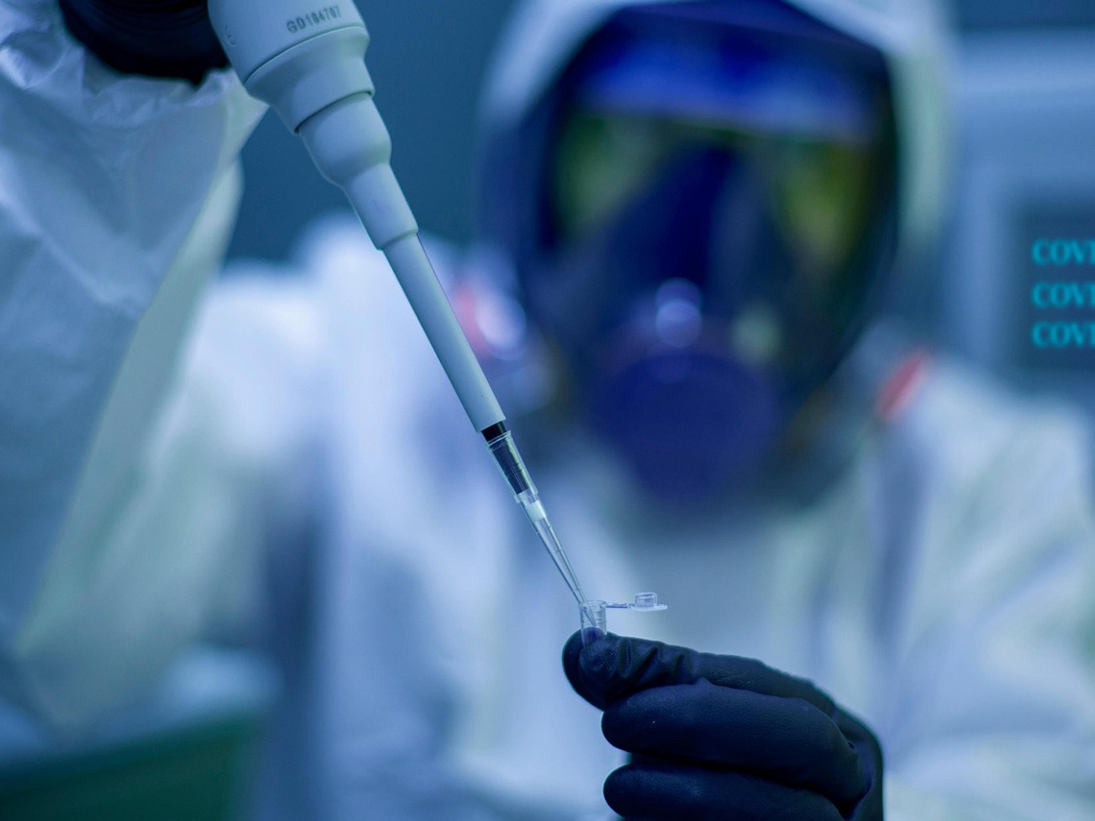Scientist handling laboratory samples during biomedical research