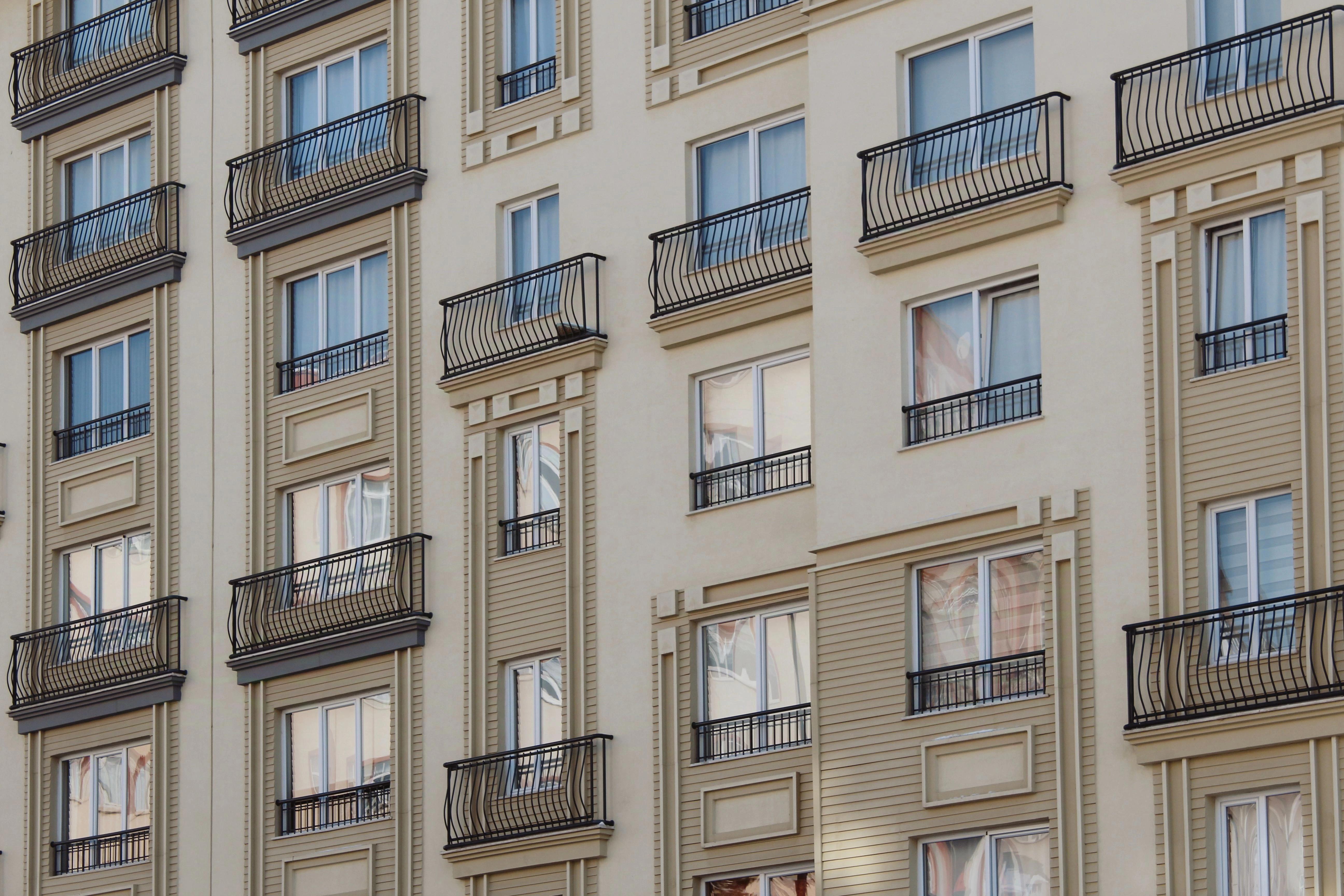 Contemporary apartment buildings with balconies and green landscaping in daylight