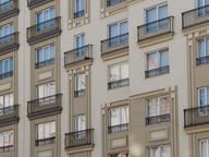 Contemporary apartment buildings with balconies and green landscaping in daylight