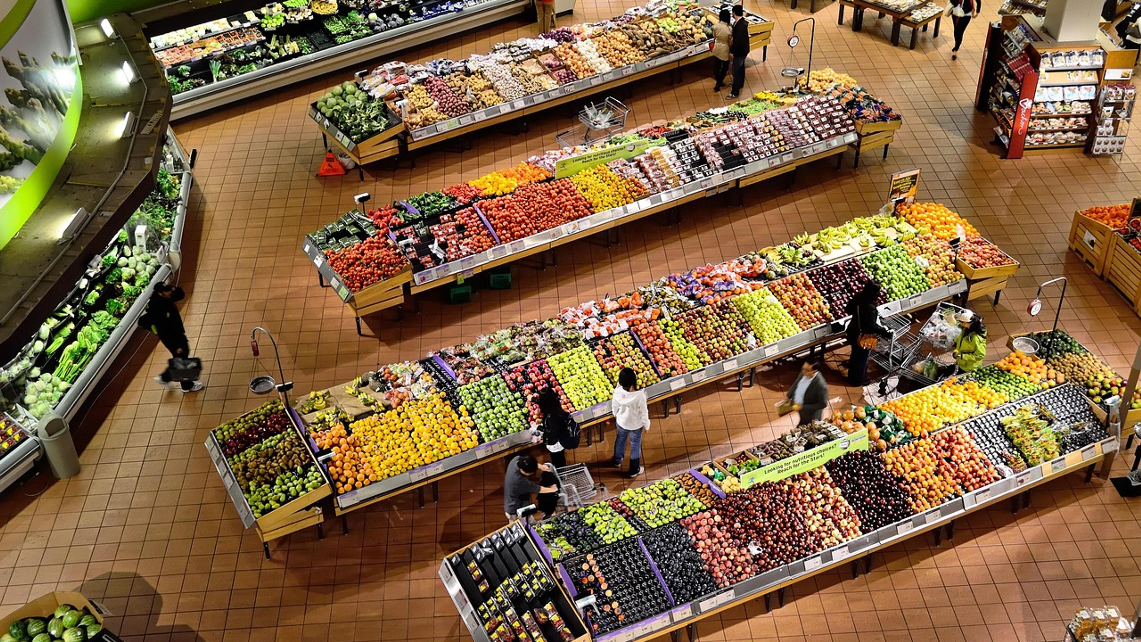Market stall stocked with fresh vegetables and fruit