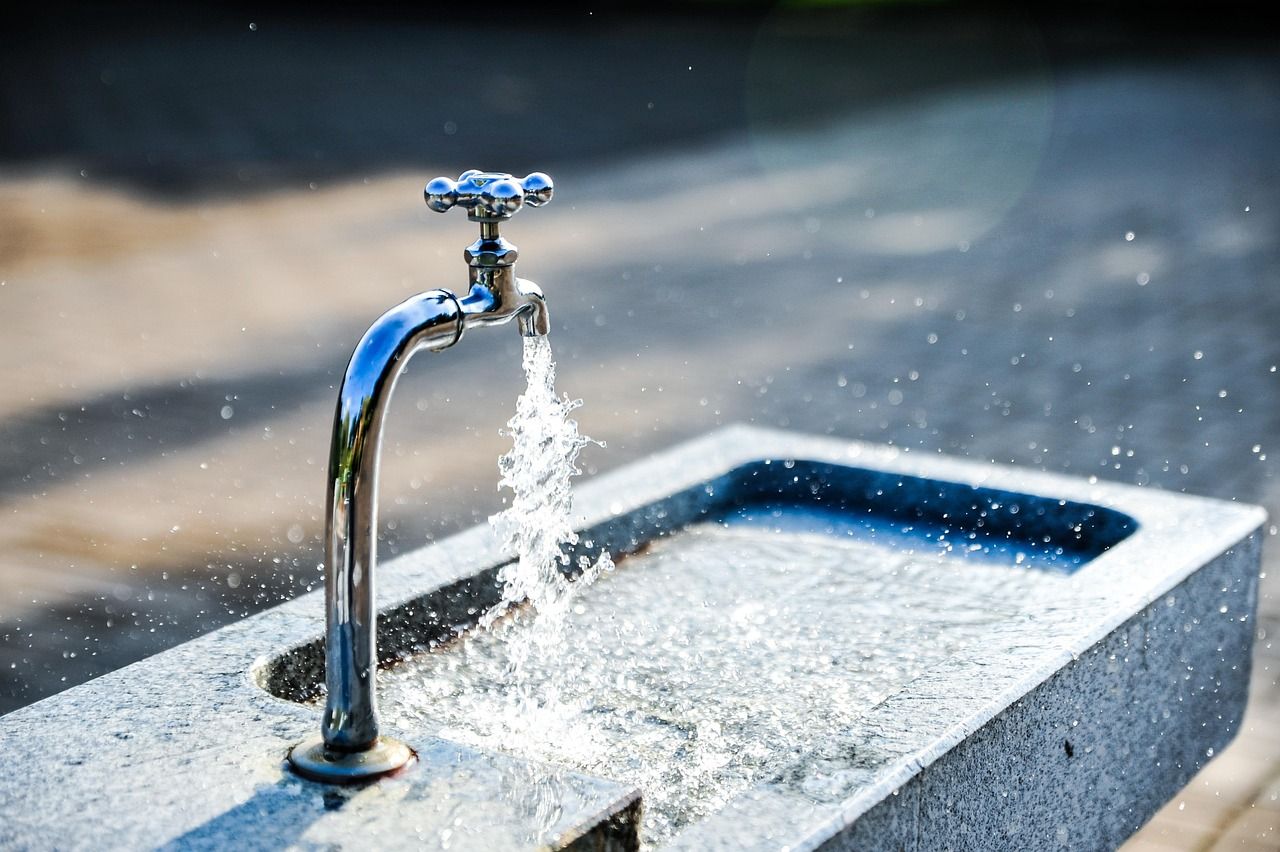 Clean water flowing from a metal tap