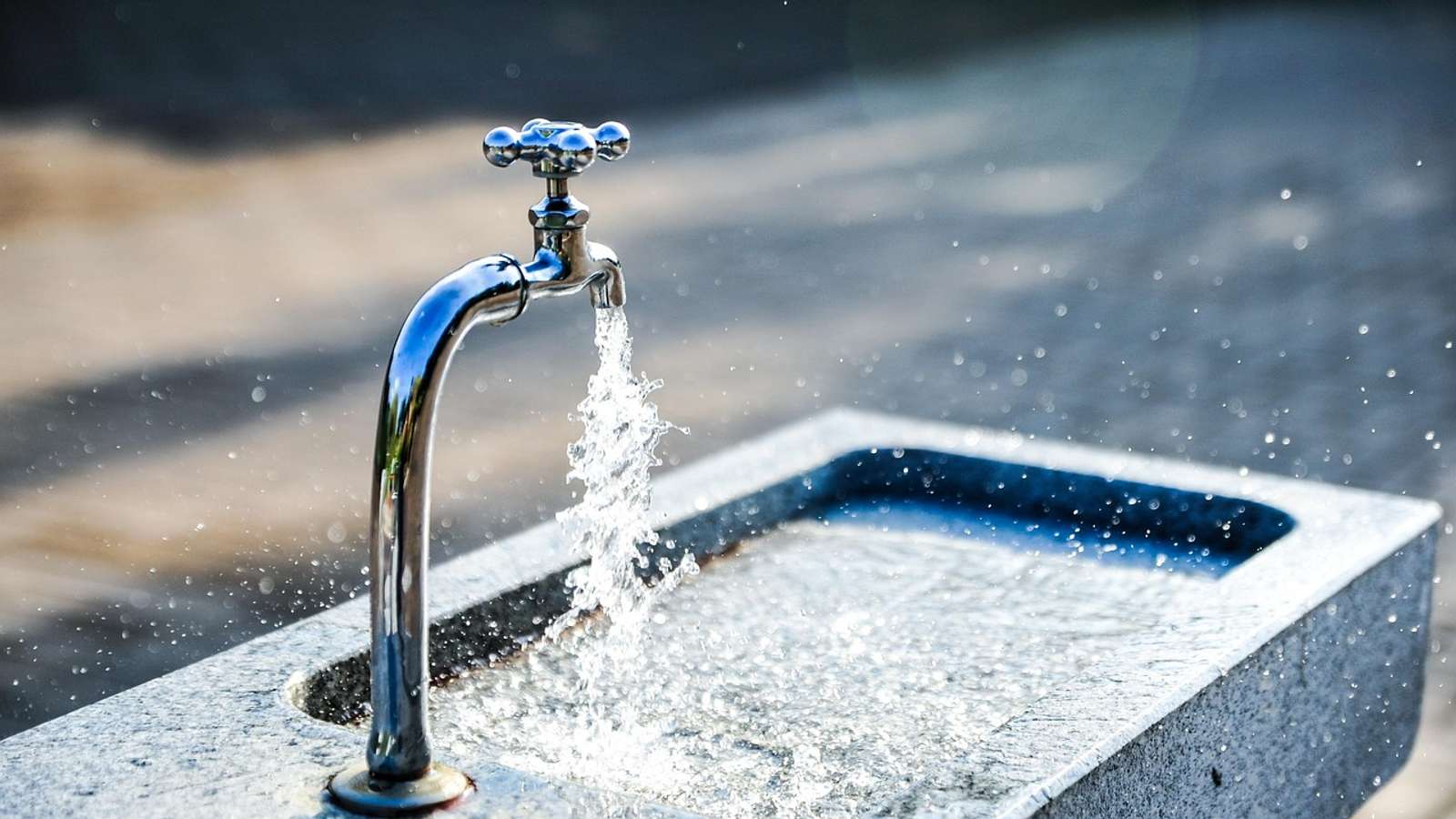 Clean water flowing from a metal tap