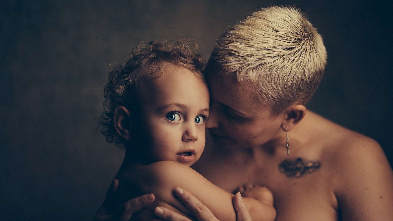 A mother hugging her toddler