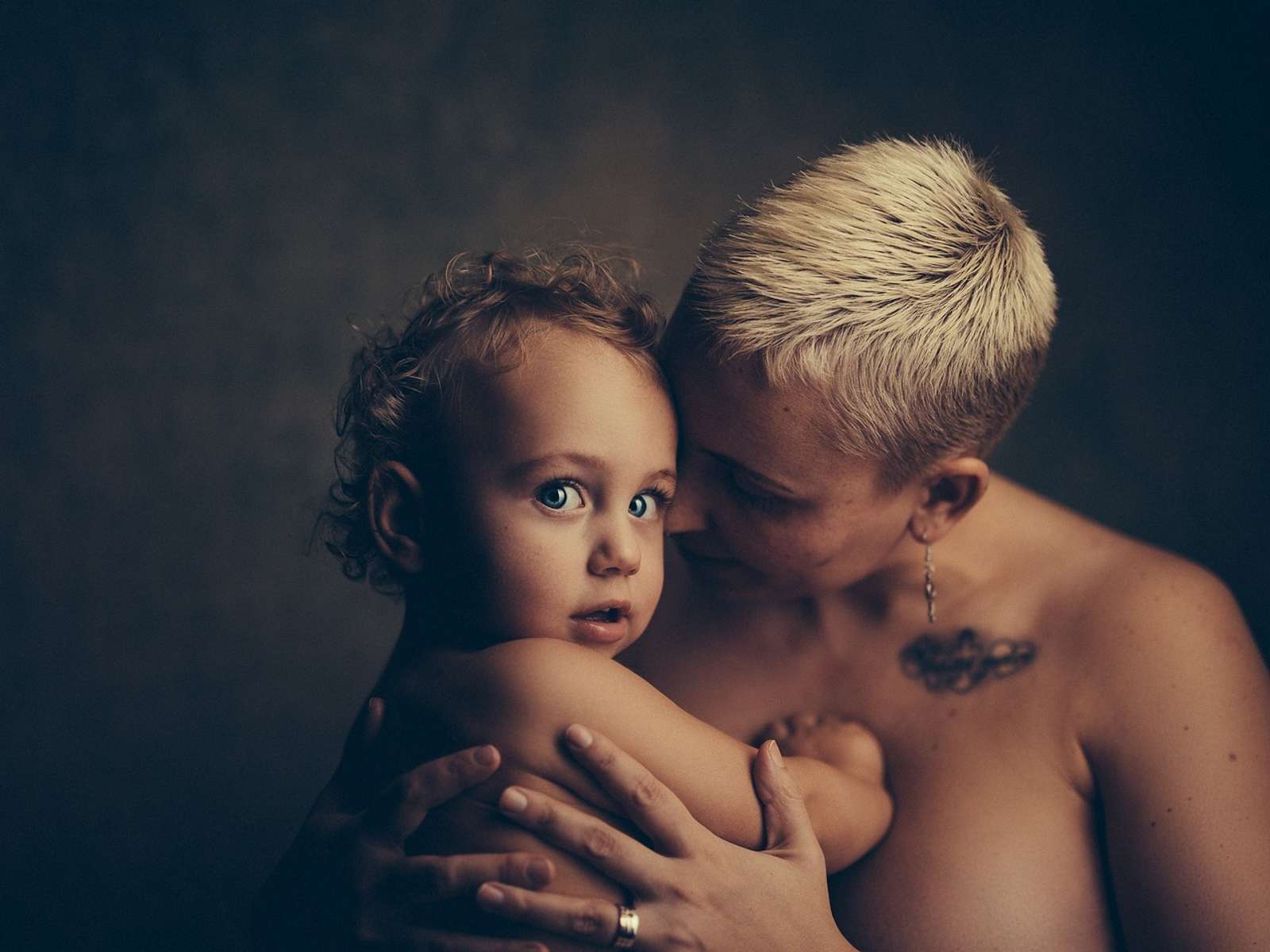 A mother hugging her toddler