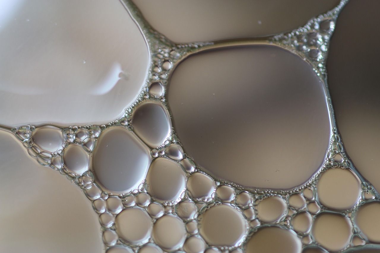 Close-up of oil droplets of many sizes floating in water