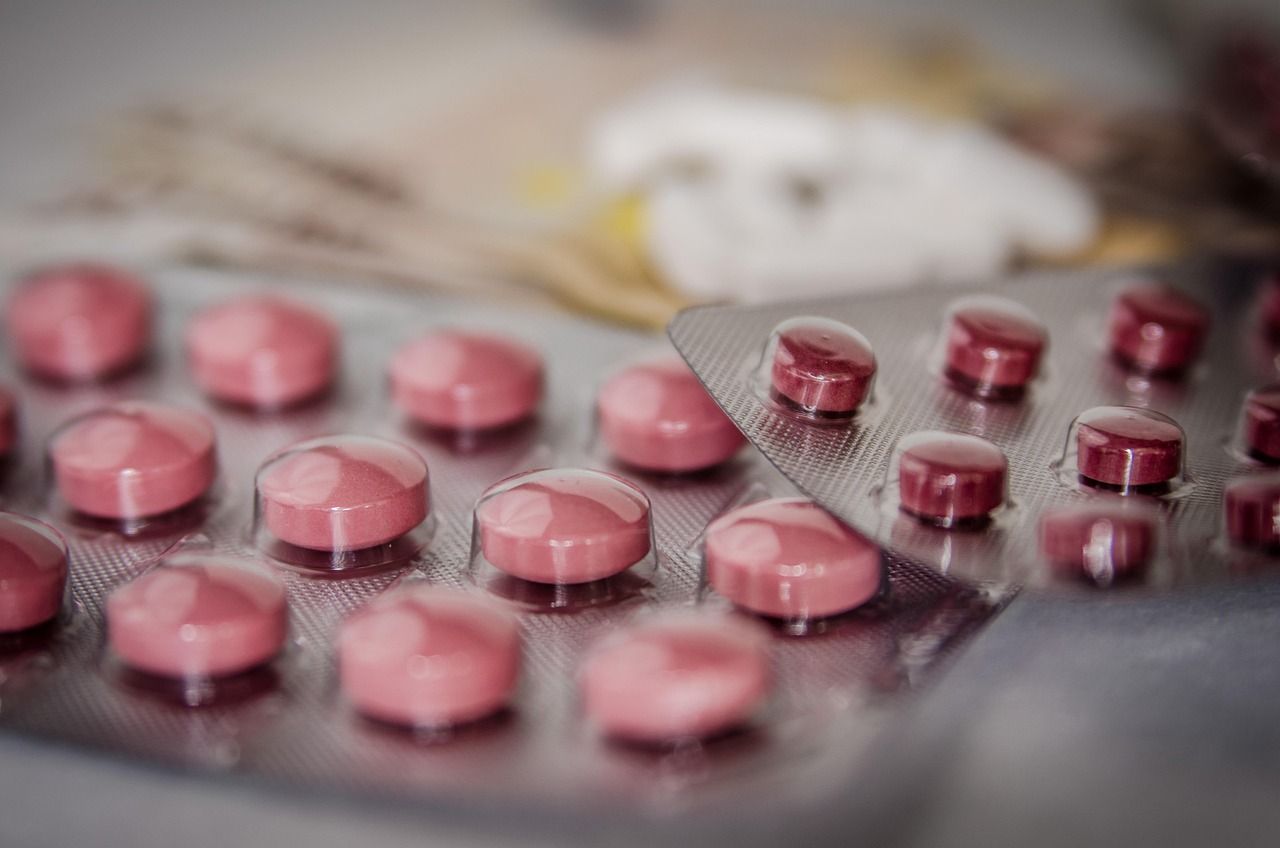 Blister packs of pink tablets on a table