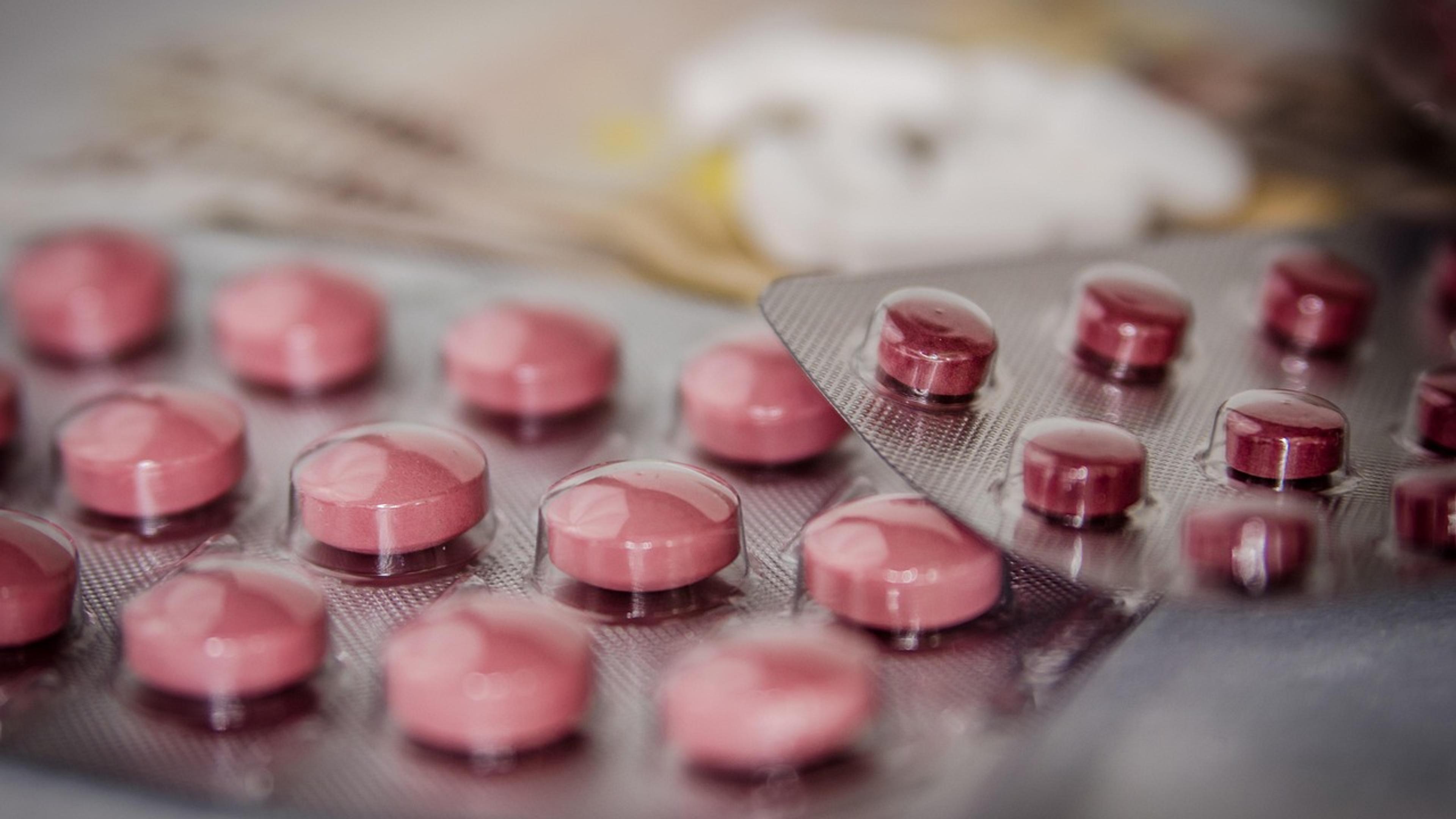 Blister packs of pink tablets on a table