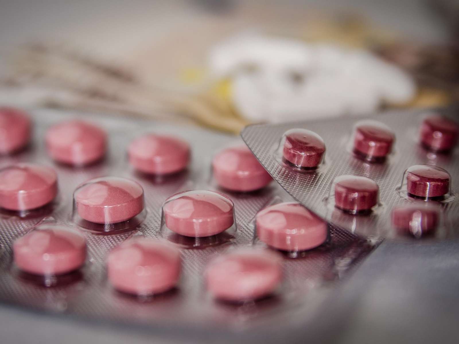 Blister packs of pink tablets on a table