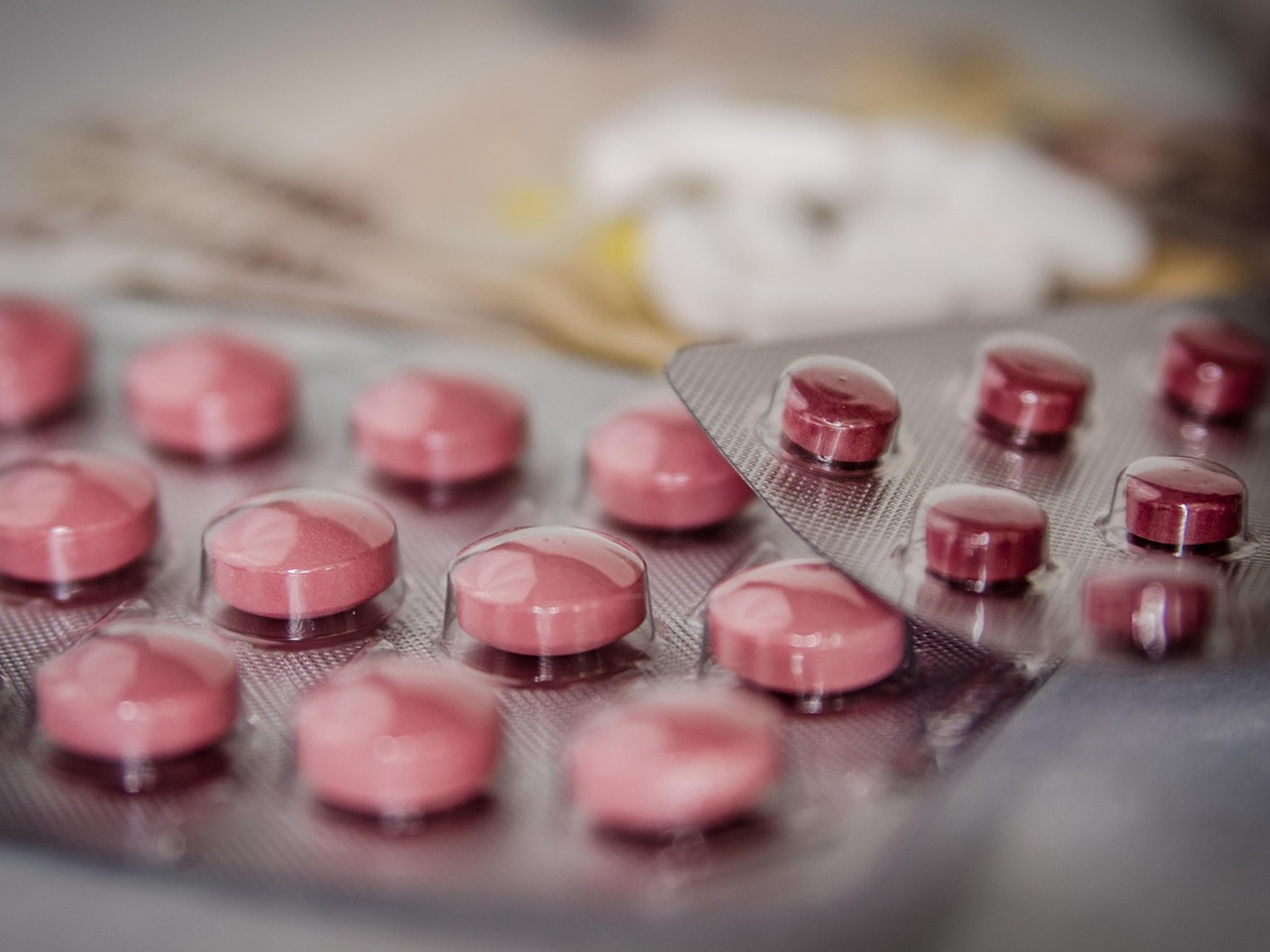 Blister packs of pink tablets on a table