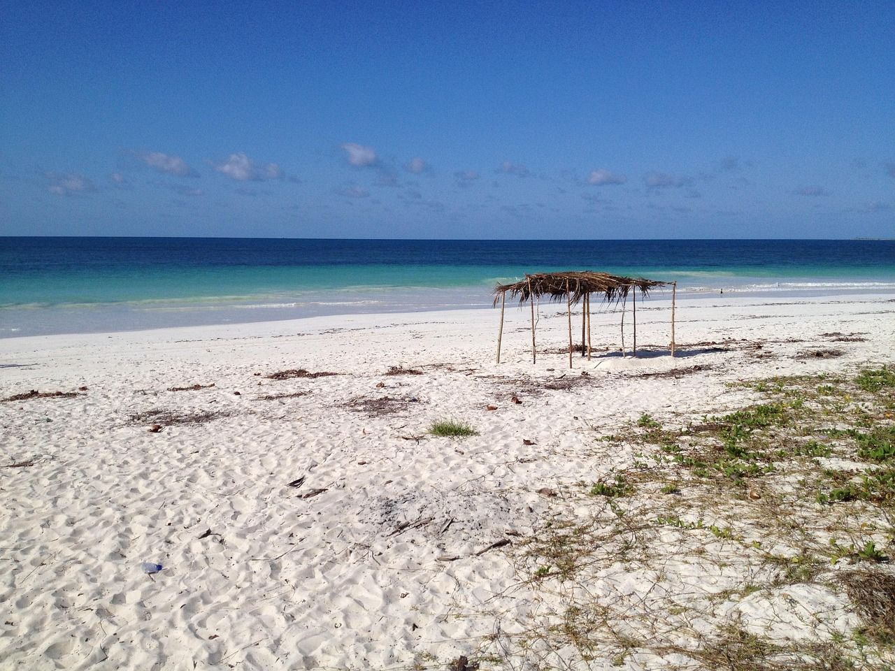 Turquoise water and a sandy shoreline along the coast of Mozambique