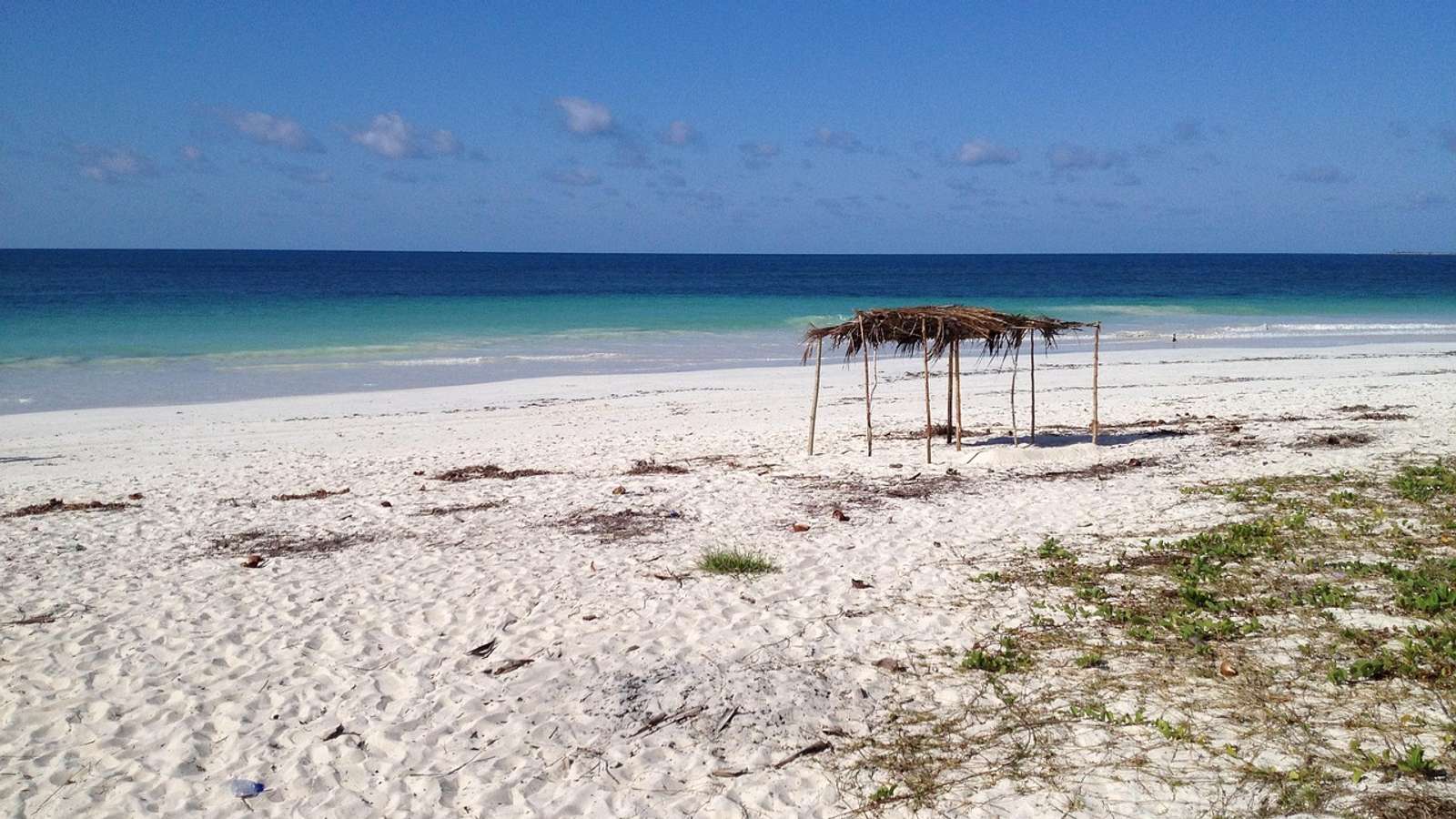 Turquoise water and a sandy shoreline along the coast of Mozambique